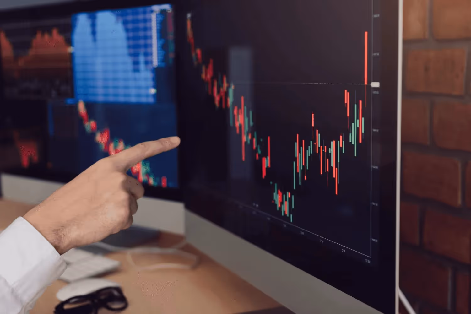 Person pointing towards screen -  Forex Trading Brokers 