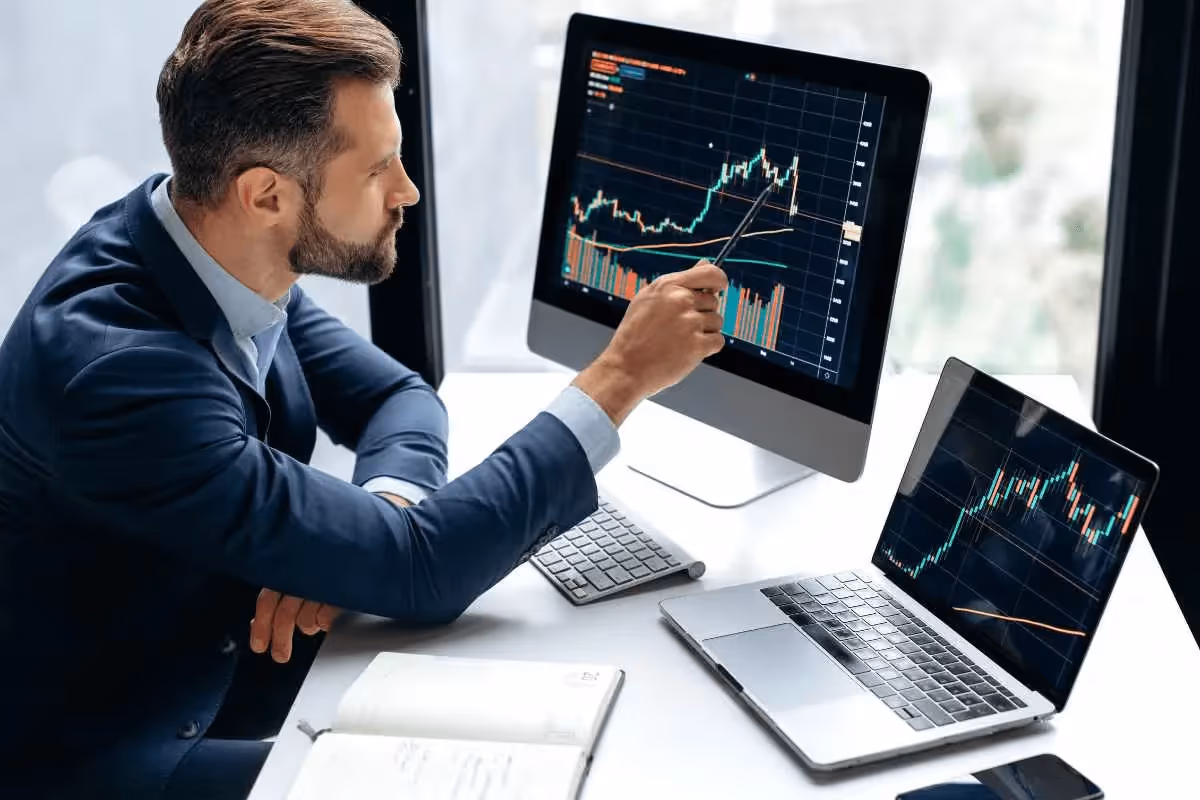 Man pointing at financial growth charts - How Does Forex Trading Work