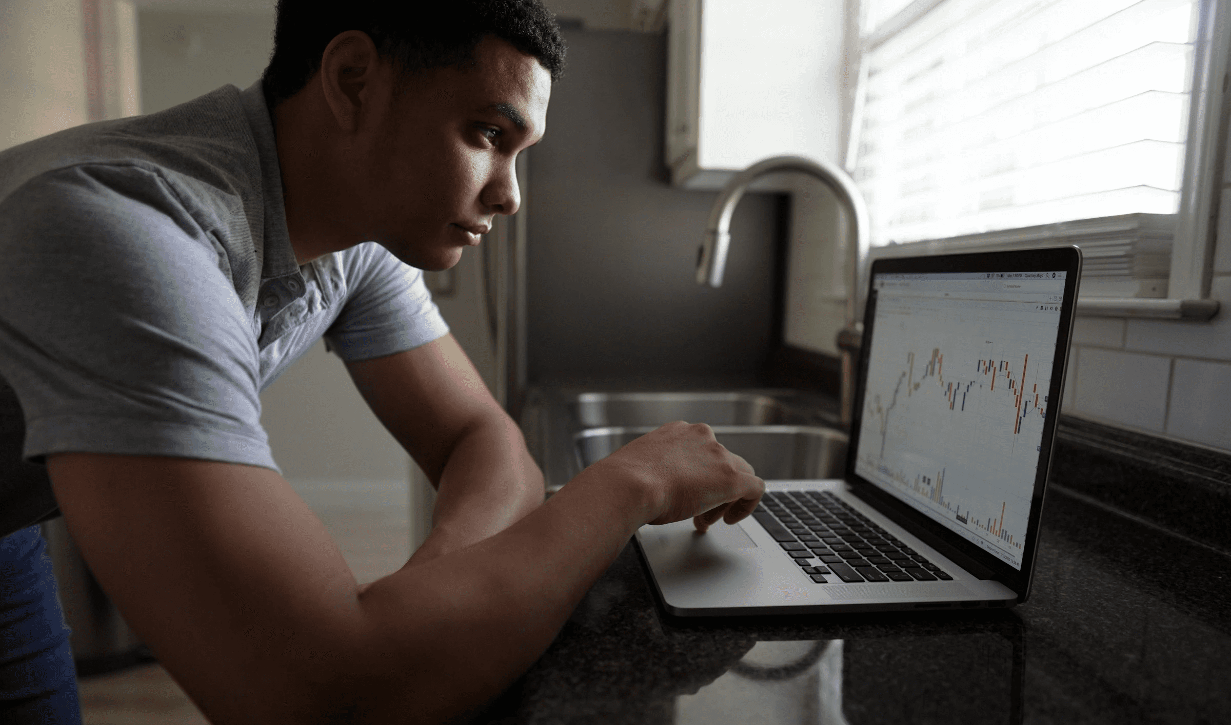 Man analyzing financial data on laptop - How to Recover from a Blown Trading Account