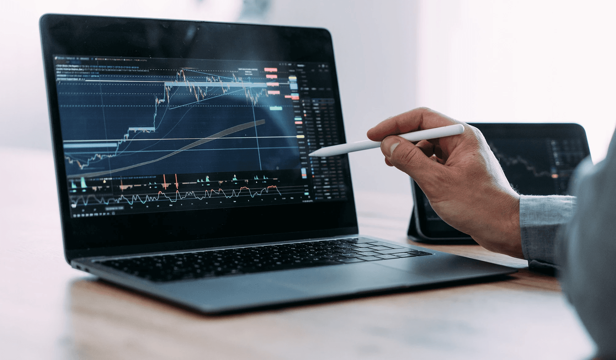 Person pointing pen at financial chart -  Best Long Term Trading Strategy