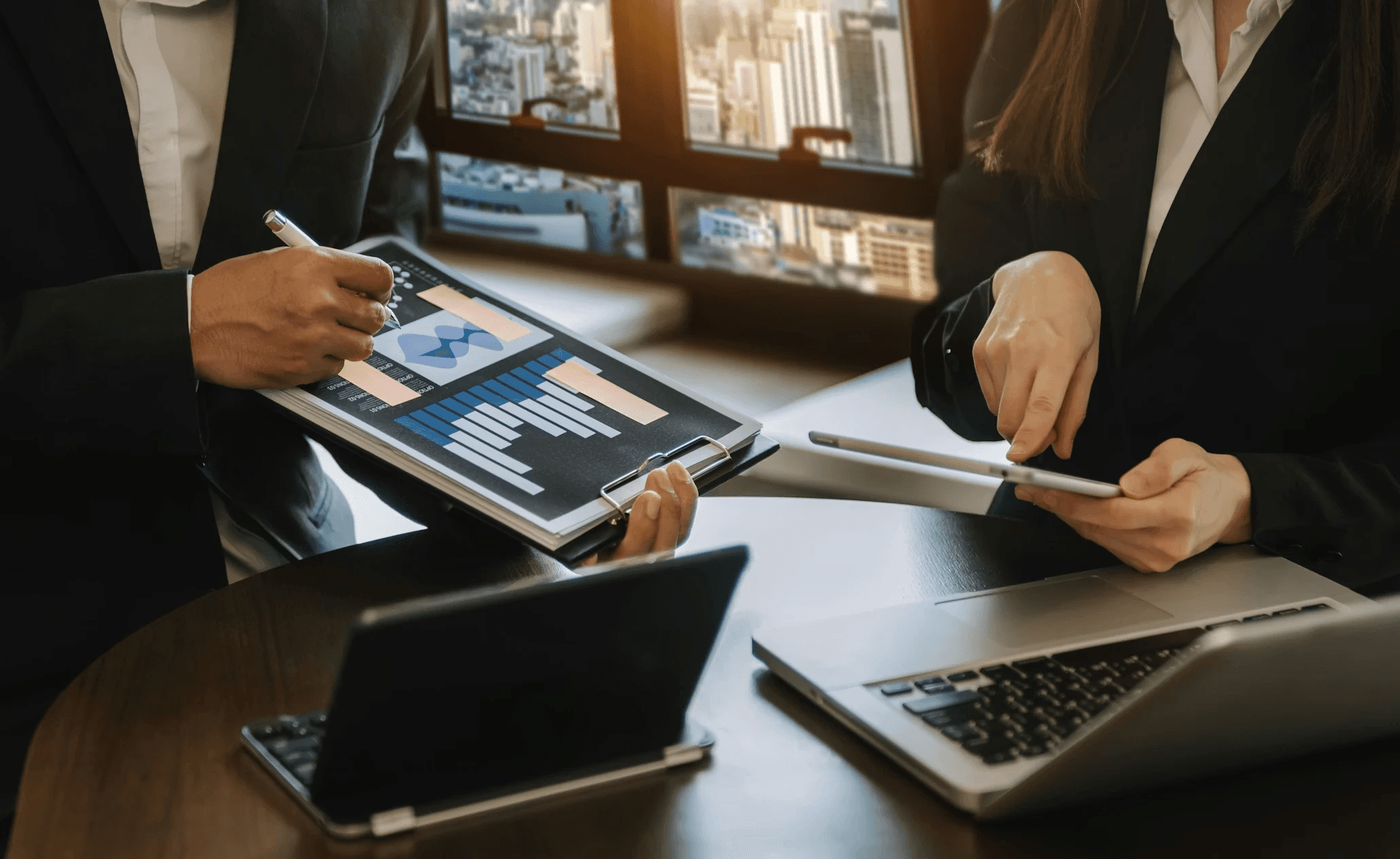 Businesspeople reviewing financial data charts - How to Evaluate Investment Opportunities