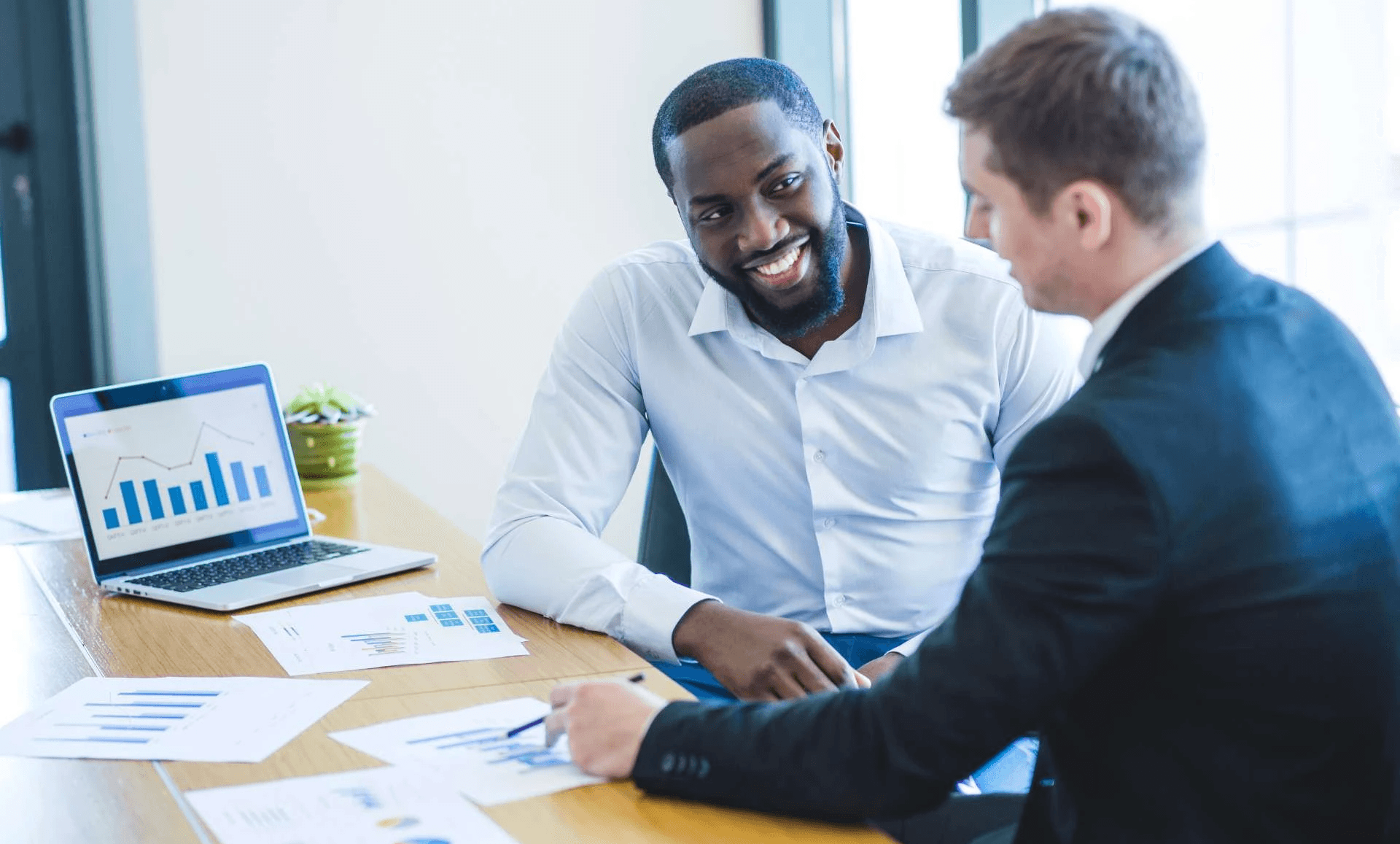 Businessmen discussing financial data charts - How to Evaluate Investment Opportunities