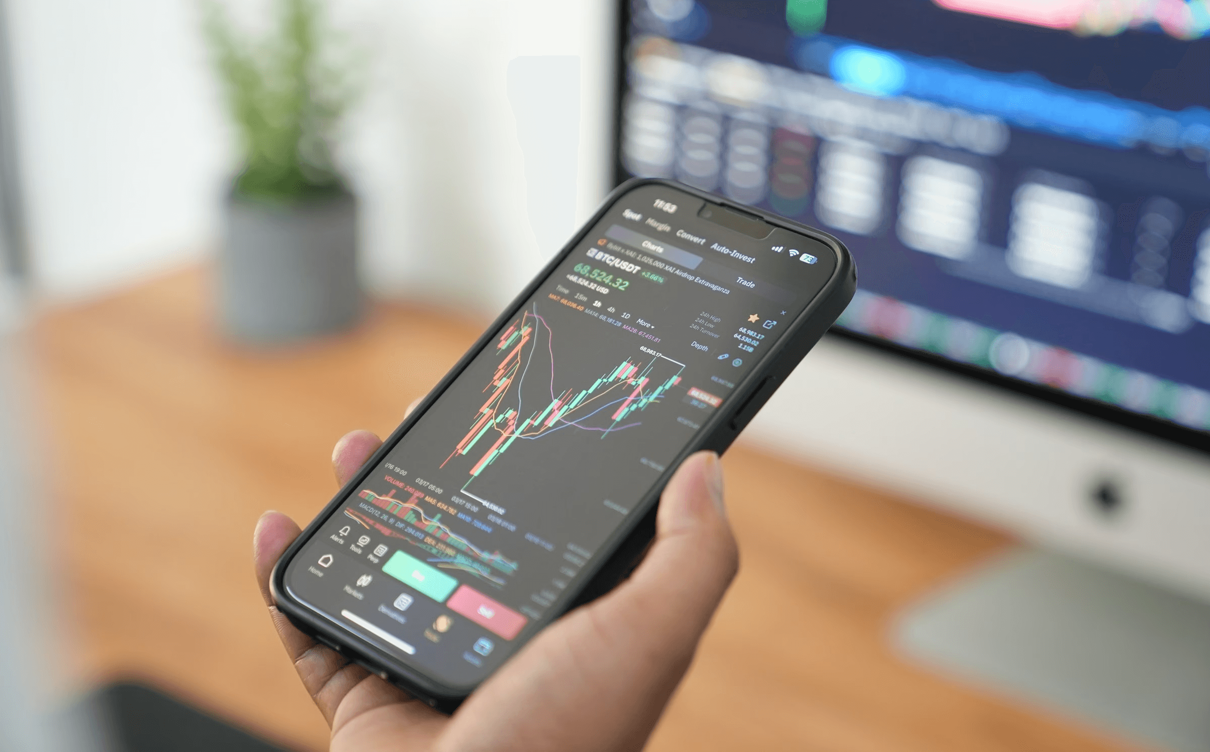 Person holding smartphone displaying stock charts -  How Much Money Do You Need to Start Trading Stocks