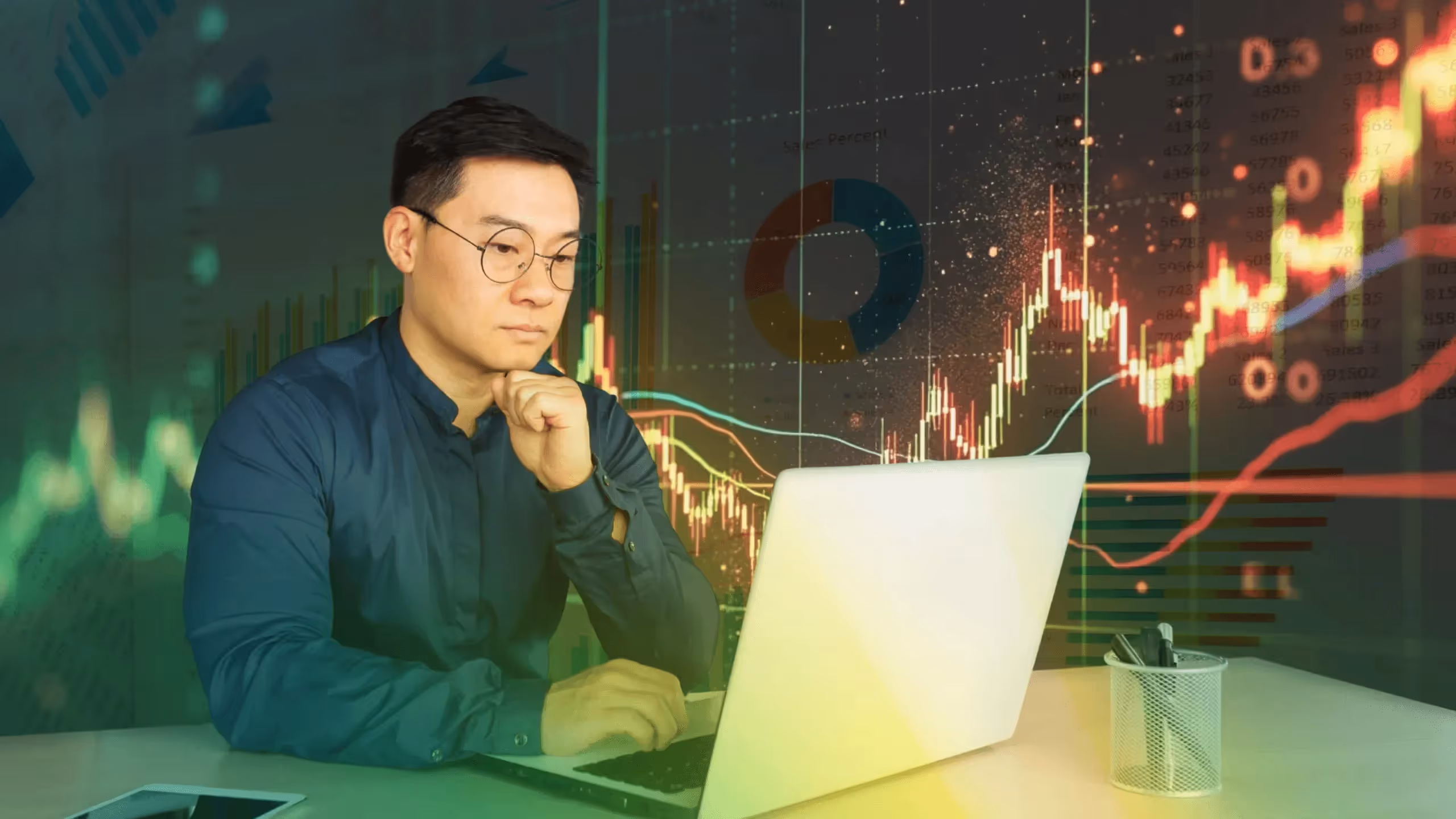  Man analyzing financial data -  How Much Money Do You Need to Start Trading Stocks