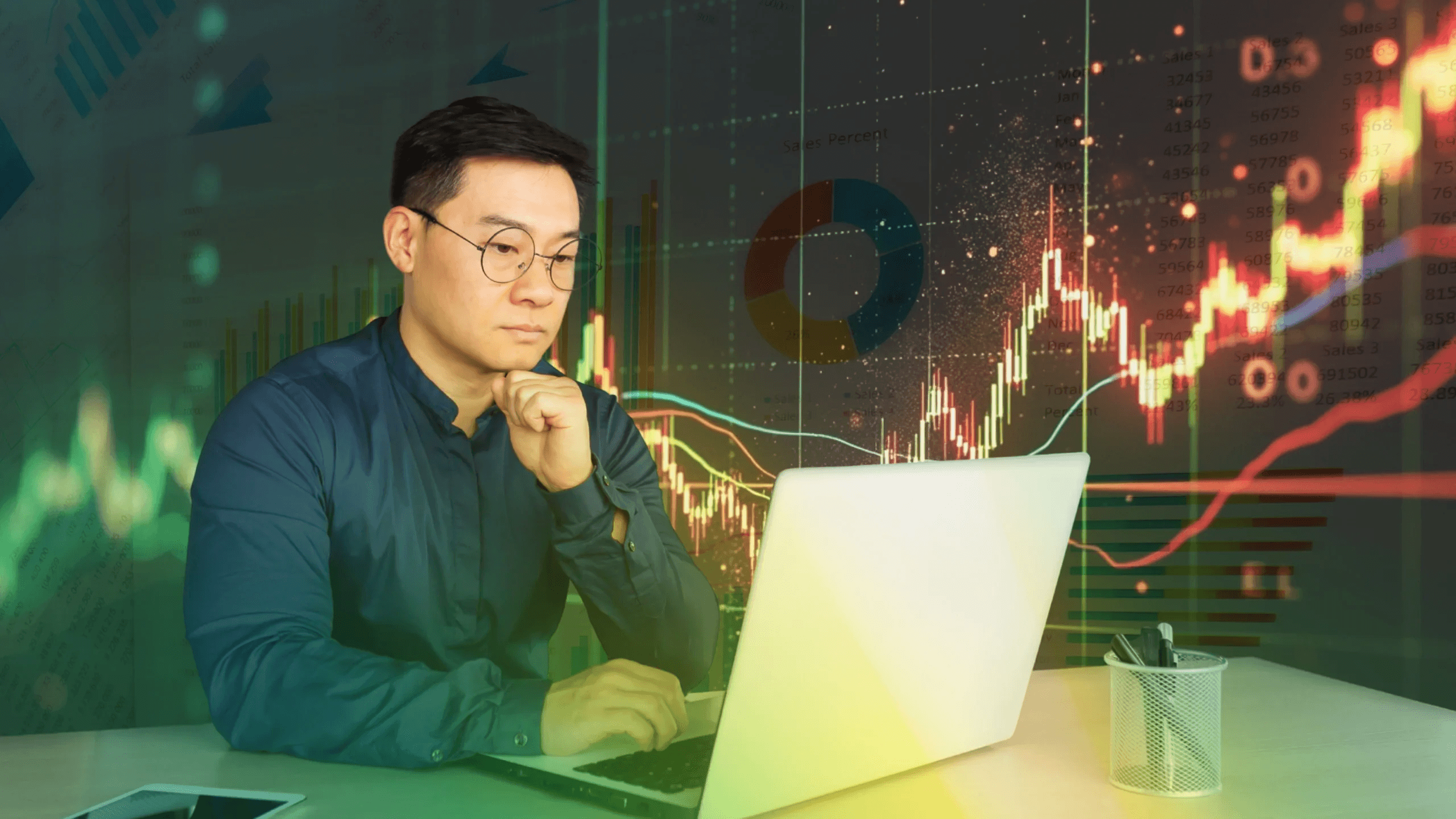  Man analyzing financial data -  How Much Money Do You Need to Start Trading Stocks