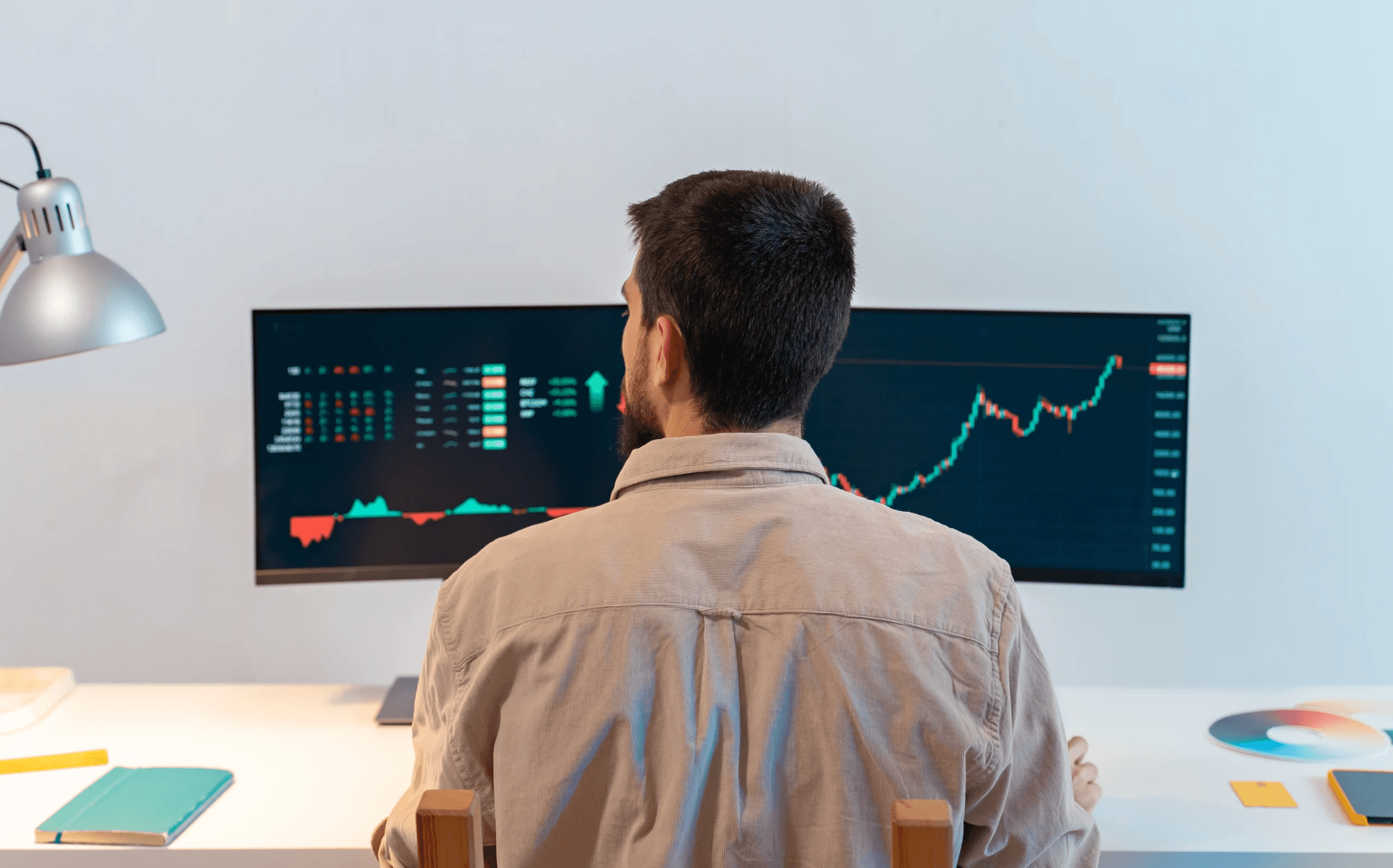 Man monitoring stock market data - Compound Trading