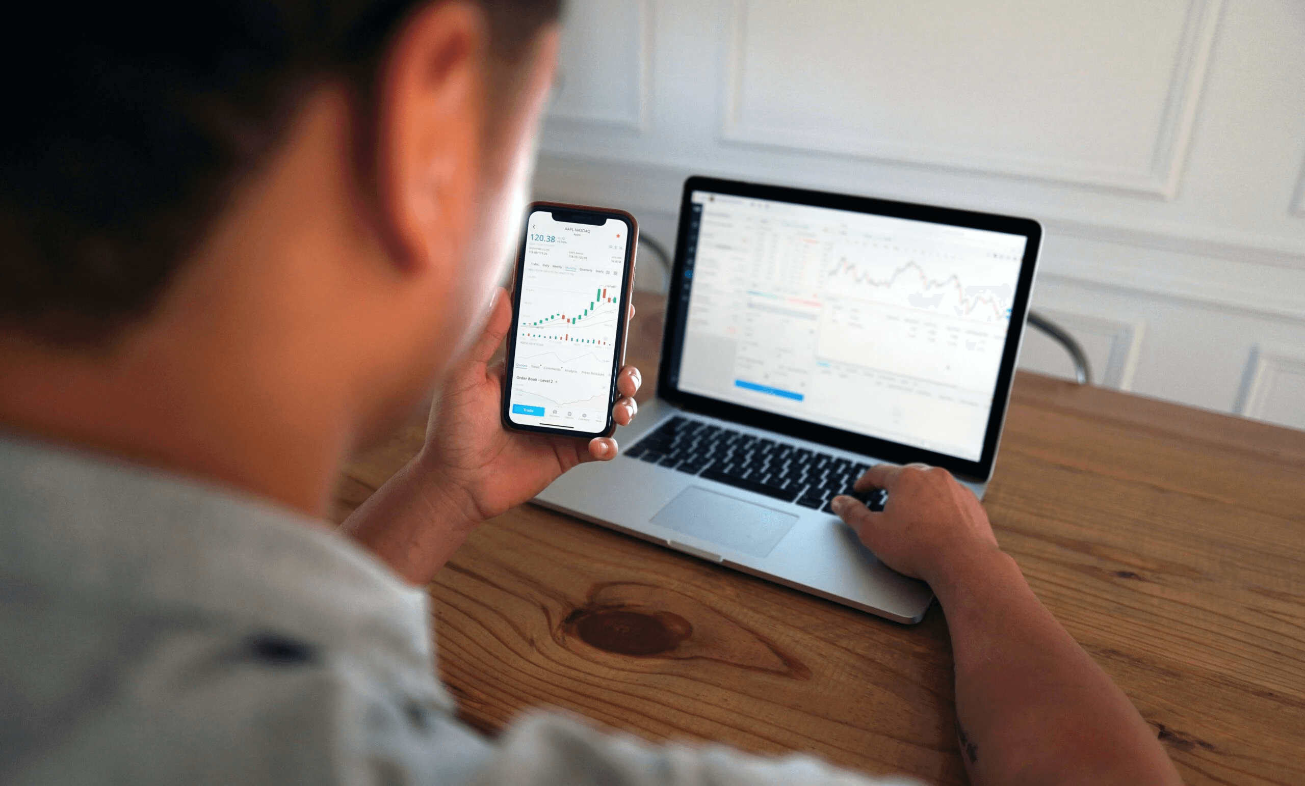 Man analyzing charts on multiple devices - Borrowing on Margin