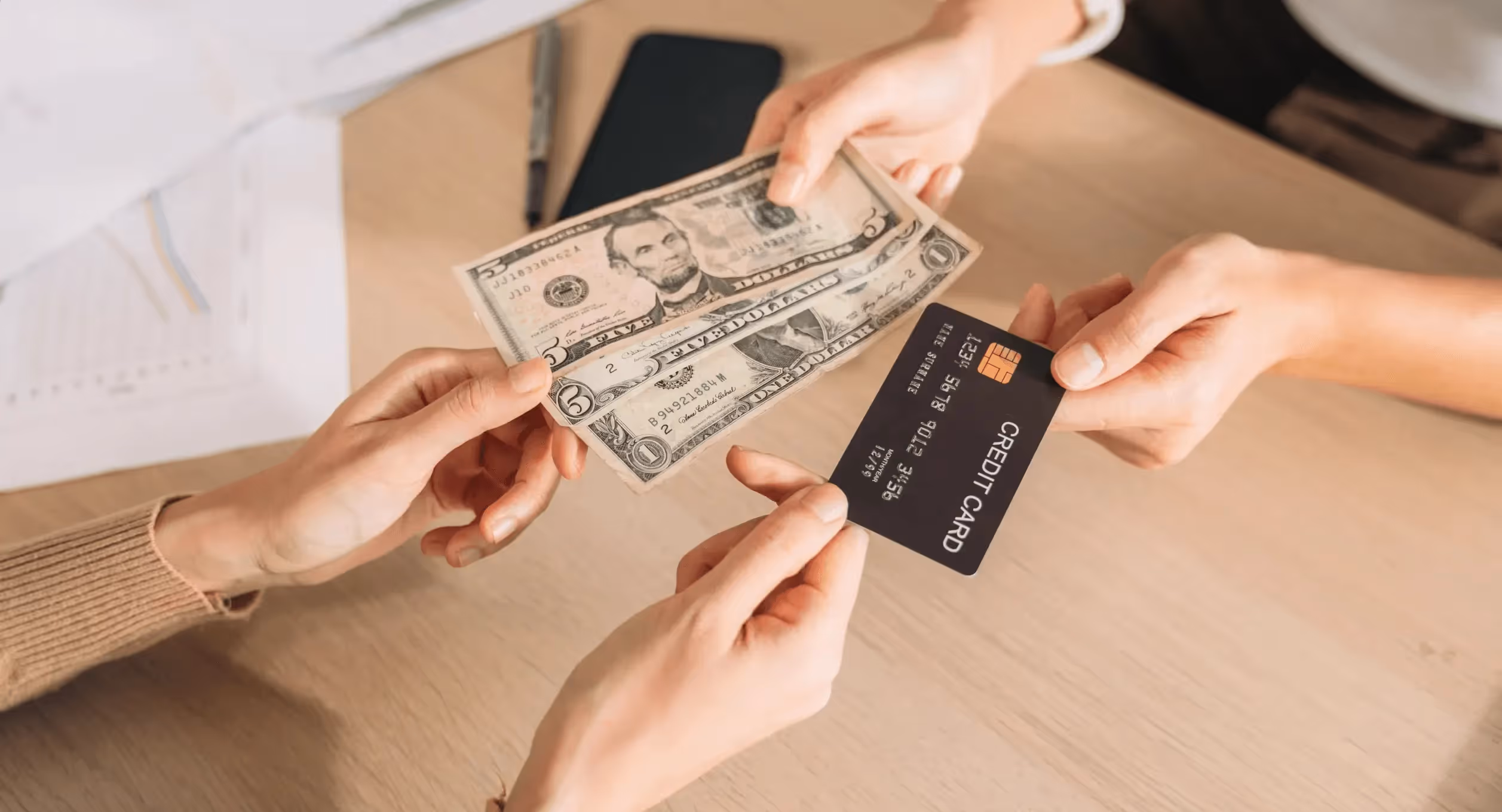 Hands exchanging cash and credit card - Cash Reserve Account