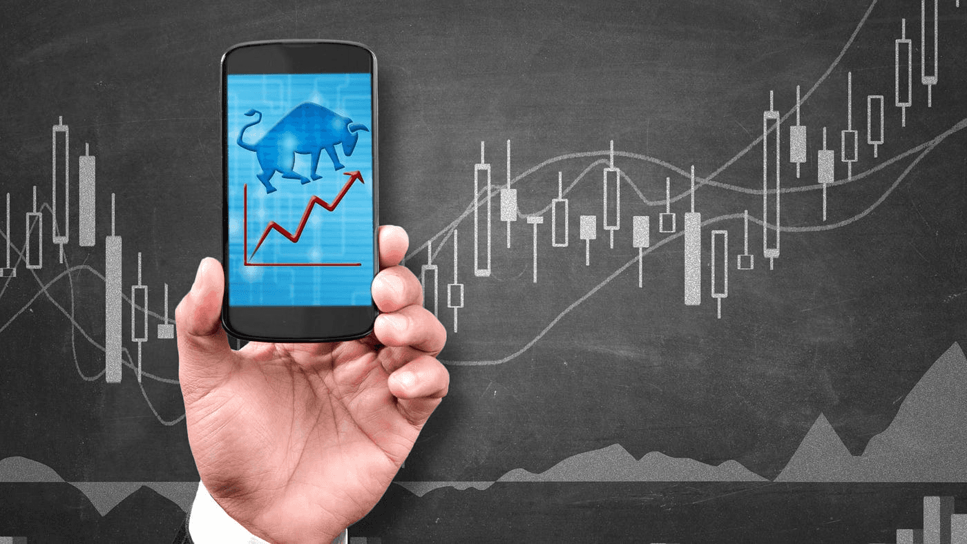 Person holding phone with bull market - Short Term Stock Trading