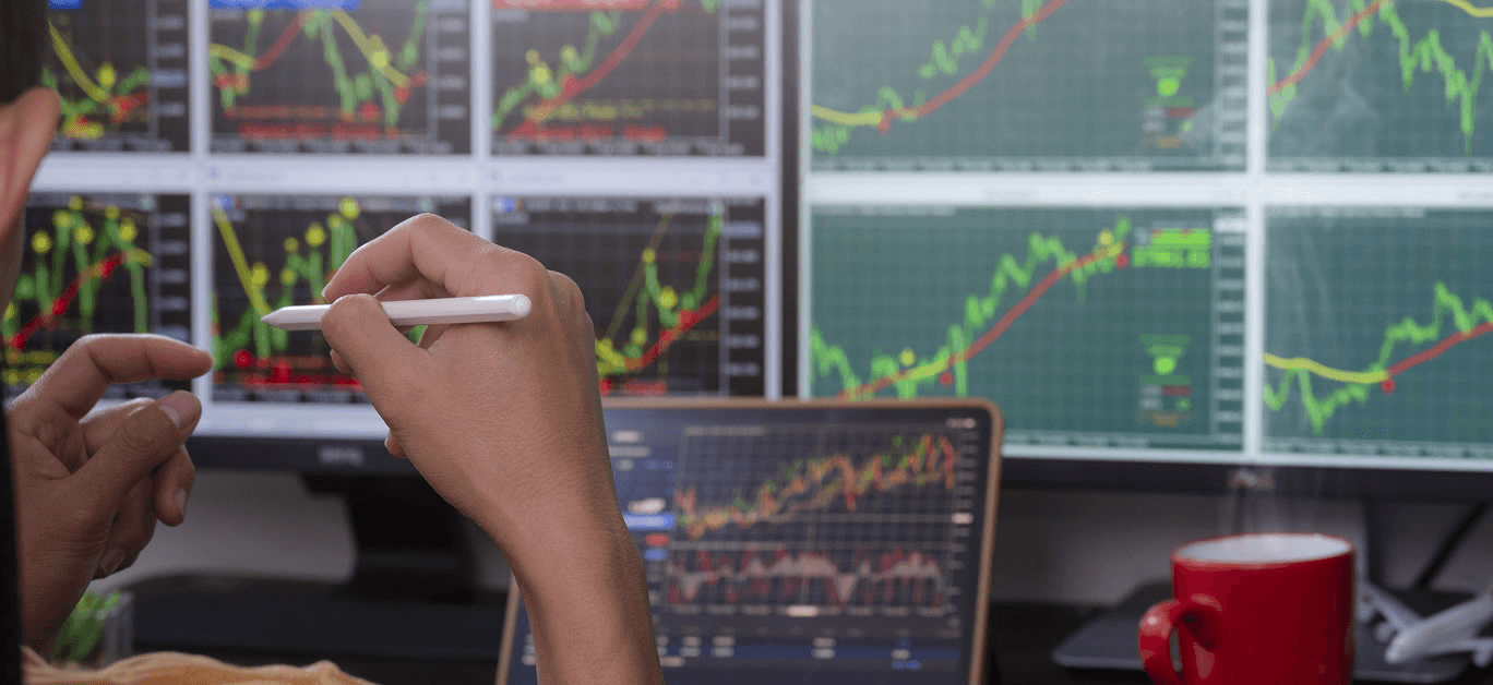  Man analyzing financial data on monitors - Short Term Stock Trading