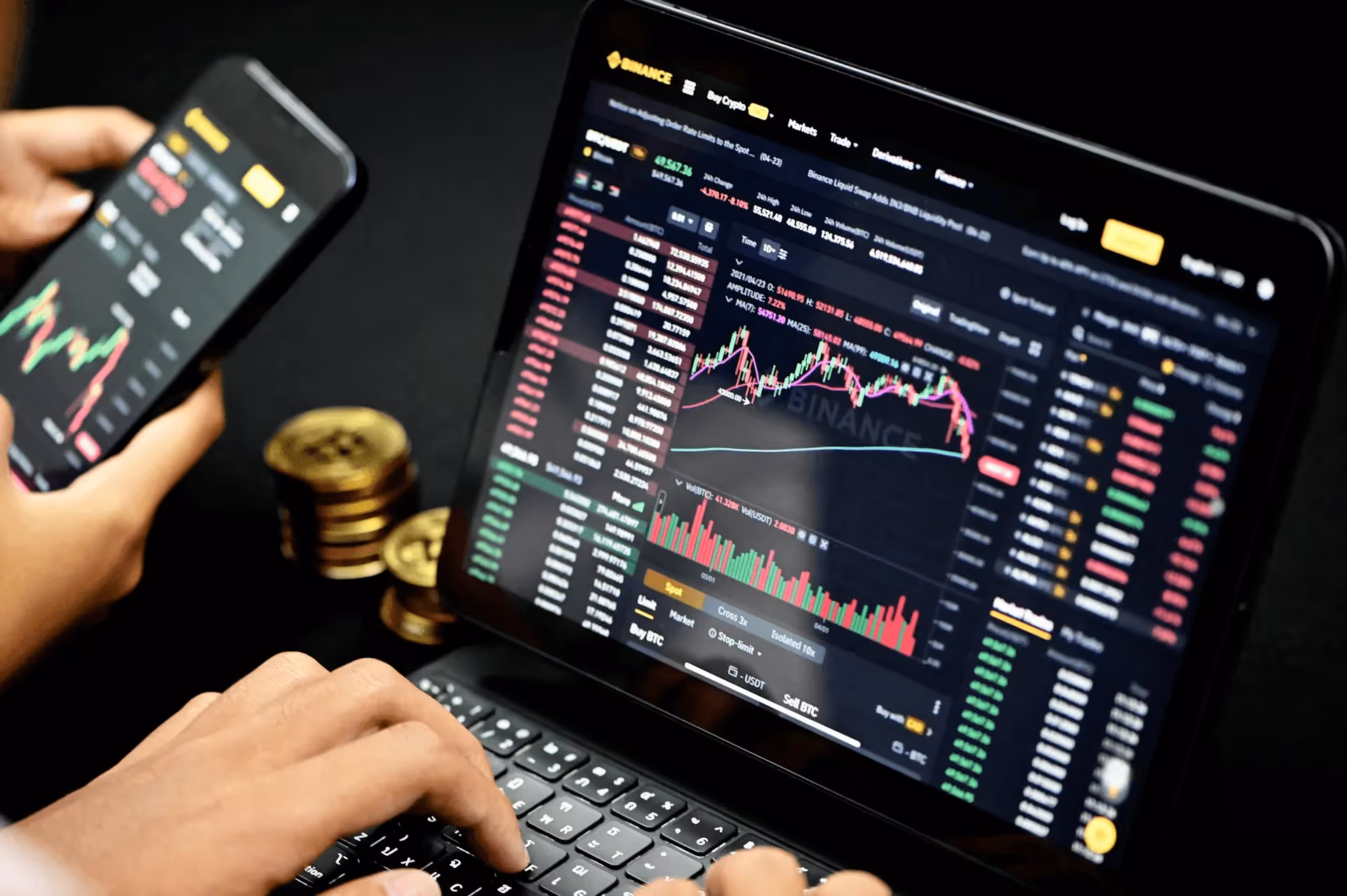 Trading cryptocurrency on laptop and phone -  How Traders Choose Prop Firms
