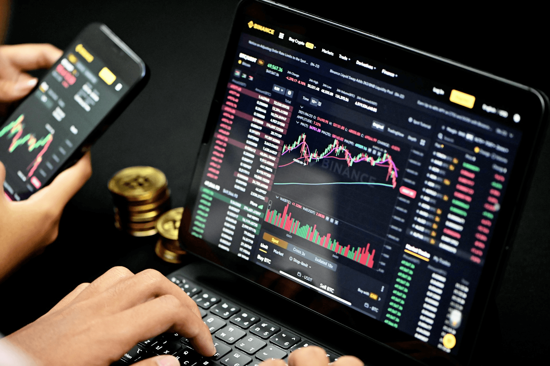 Trading cryptocurrency on laptop and phone -  How Traders Choose Prop Firms
