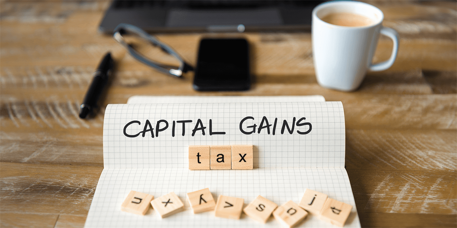  Notebook with capital gains tax text - Short Term Capital Gain Tax on Shares