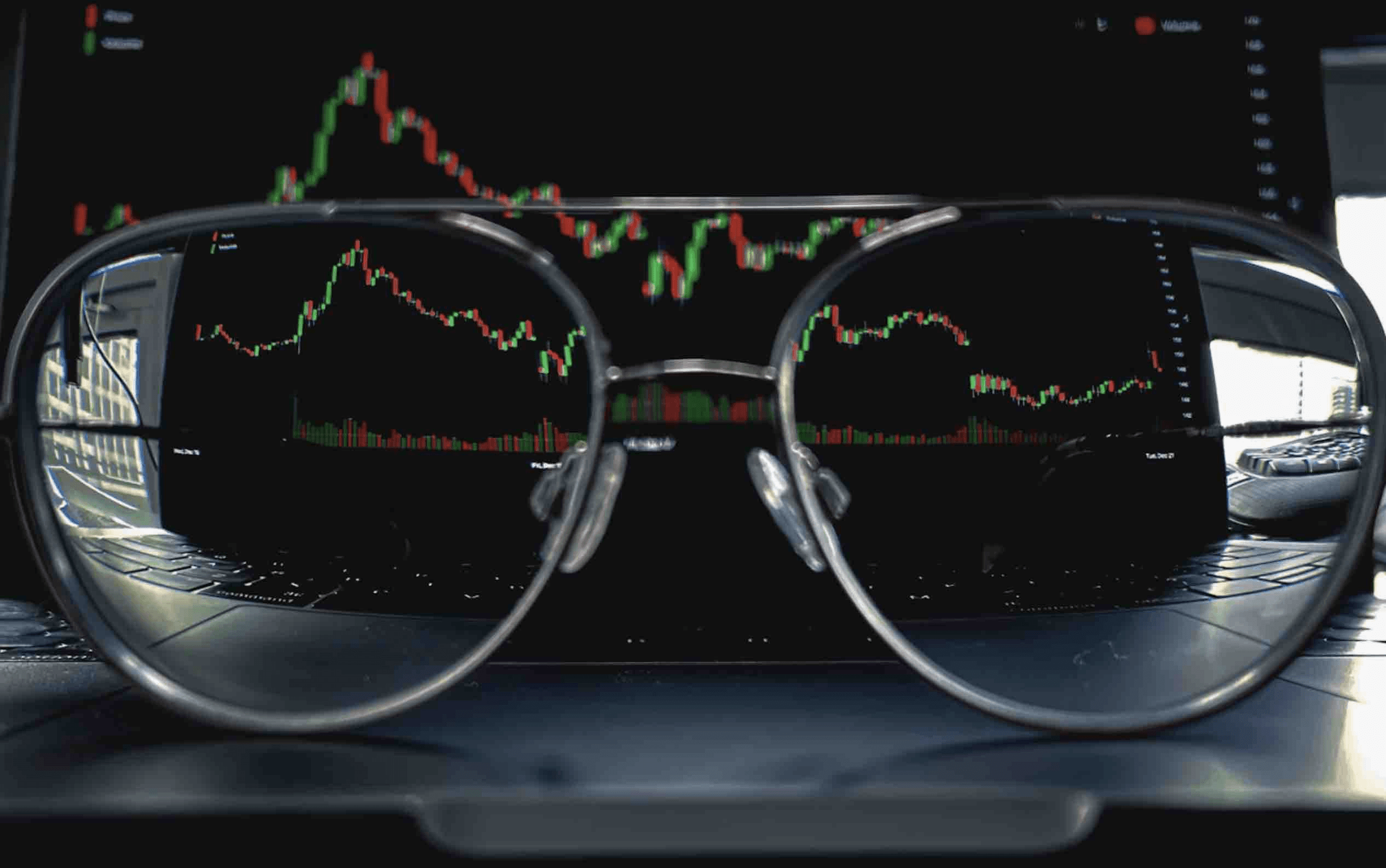 Stock market charts reflected through glasses - Prop Firm IP Address Rule