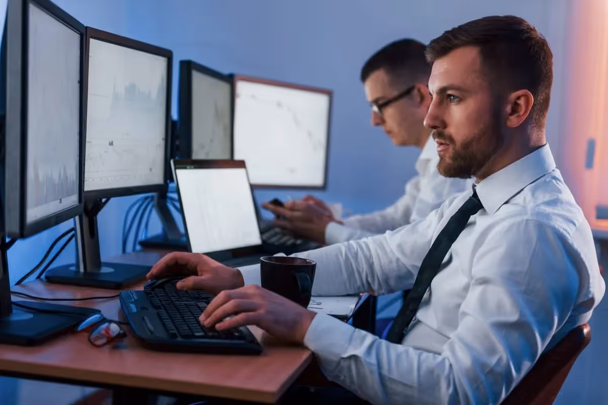 Professional occupation. Two stock traders working in the office with exchange technology