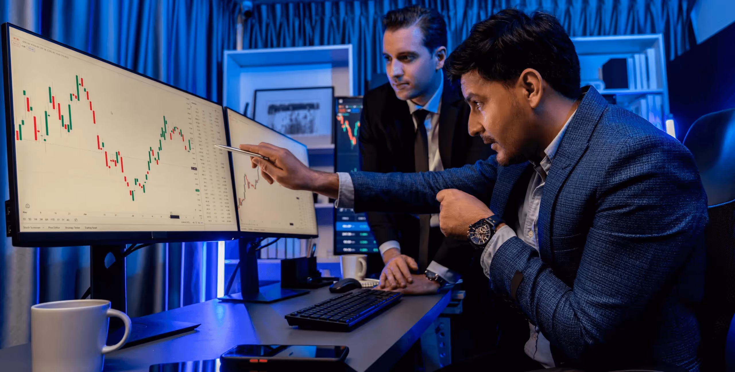 Two men analyzing financial market charts - Proprietary Trading Firms