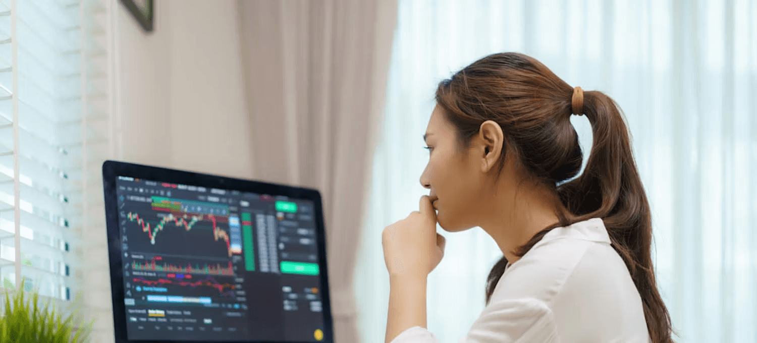 Woman analyzing market stock trading charts - Best Funded Accounts UK