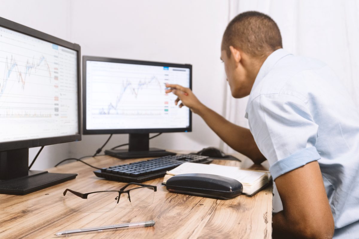 a person looking at some graphs on his screen. technology concept and trading classes