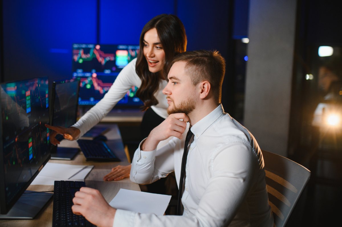 Financial professionals analyzing stock market data at night