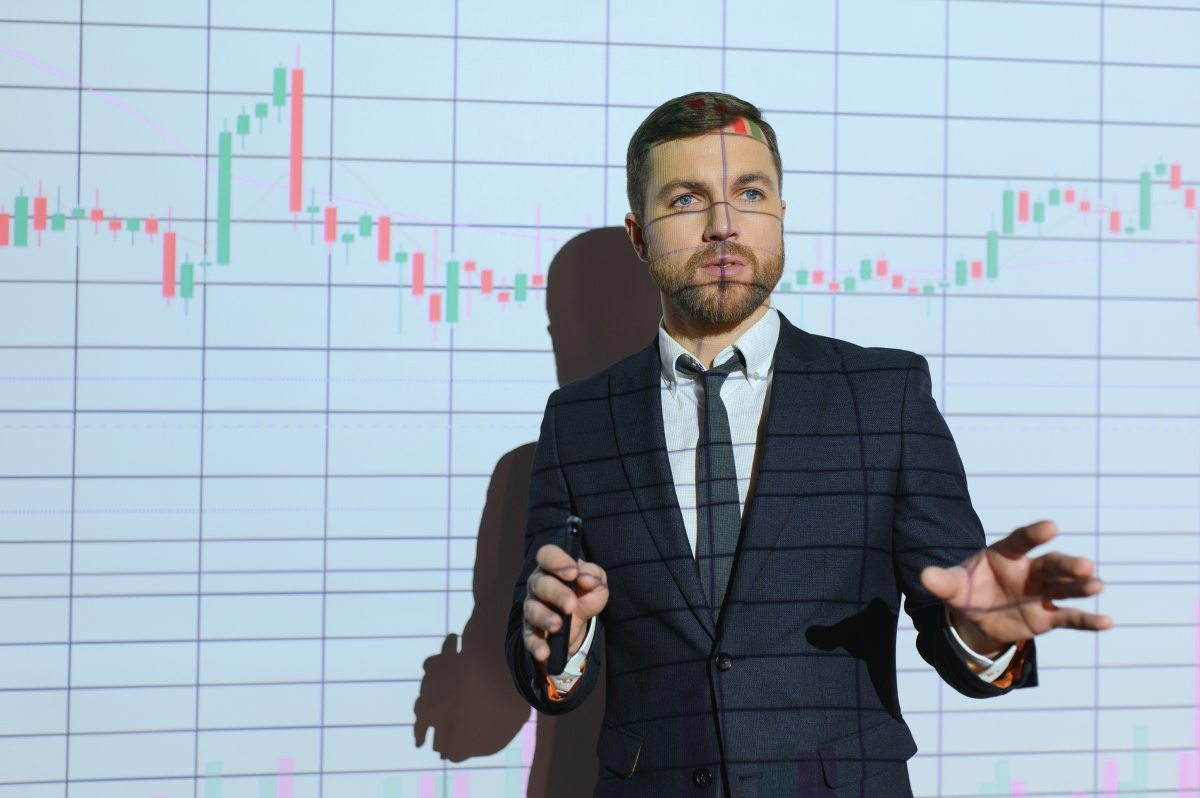 Business Conference Meeting Presentation Businessman does Financial Analysis talks to Group of Businessspeople