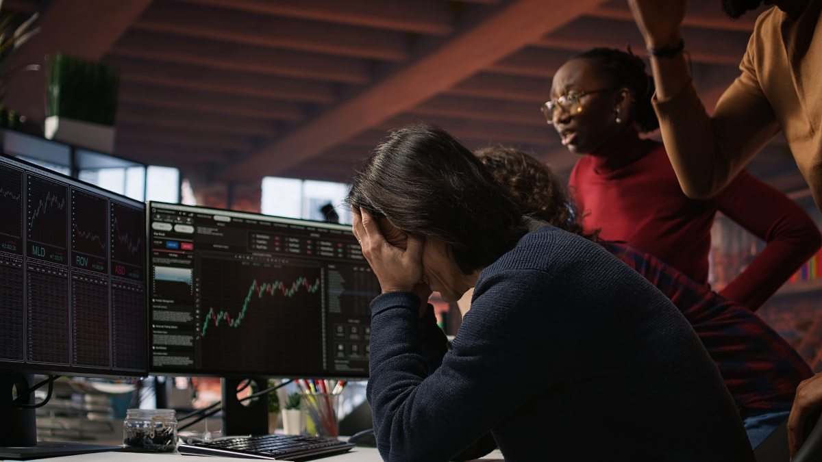 Startup team concerned by company stock valuation dropping, signaling future funding challenges