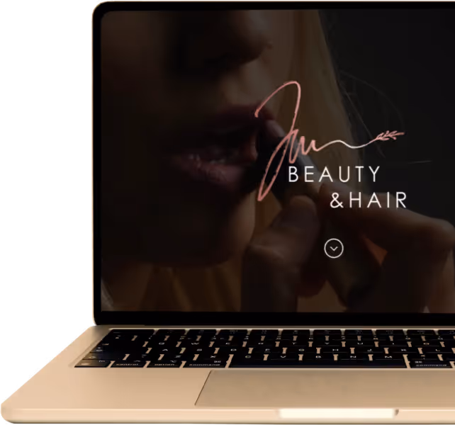 A golden MacBook showing a website designed by Marcel Schreiner