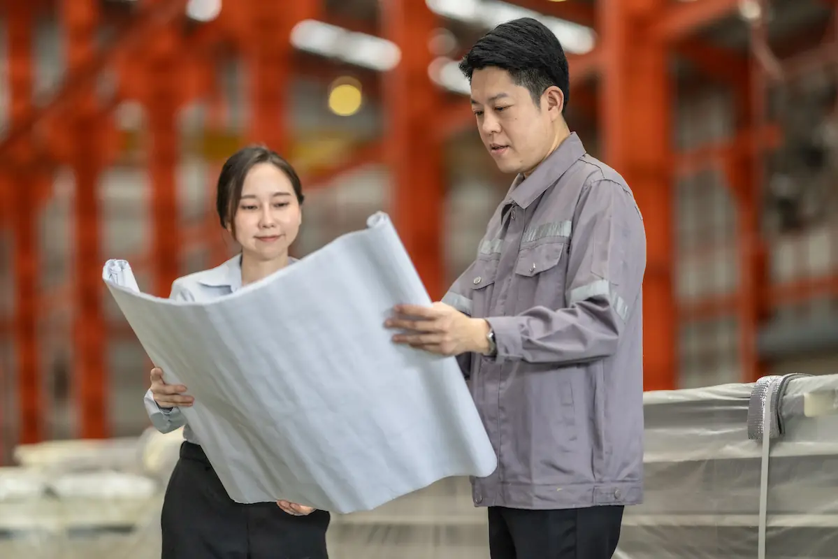 2 employees reviewing a blueprint