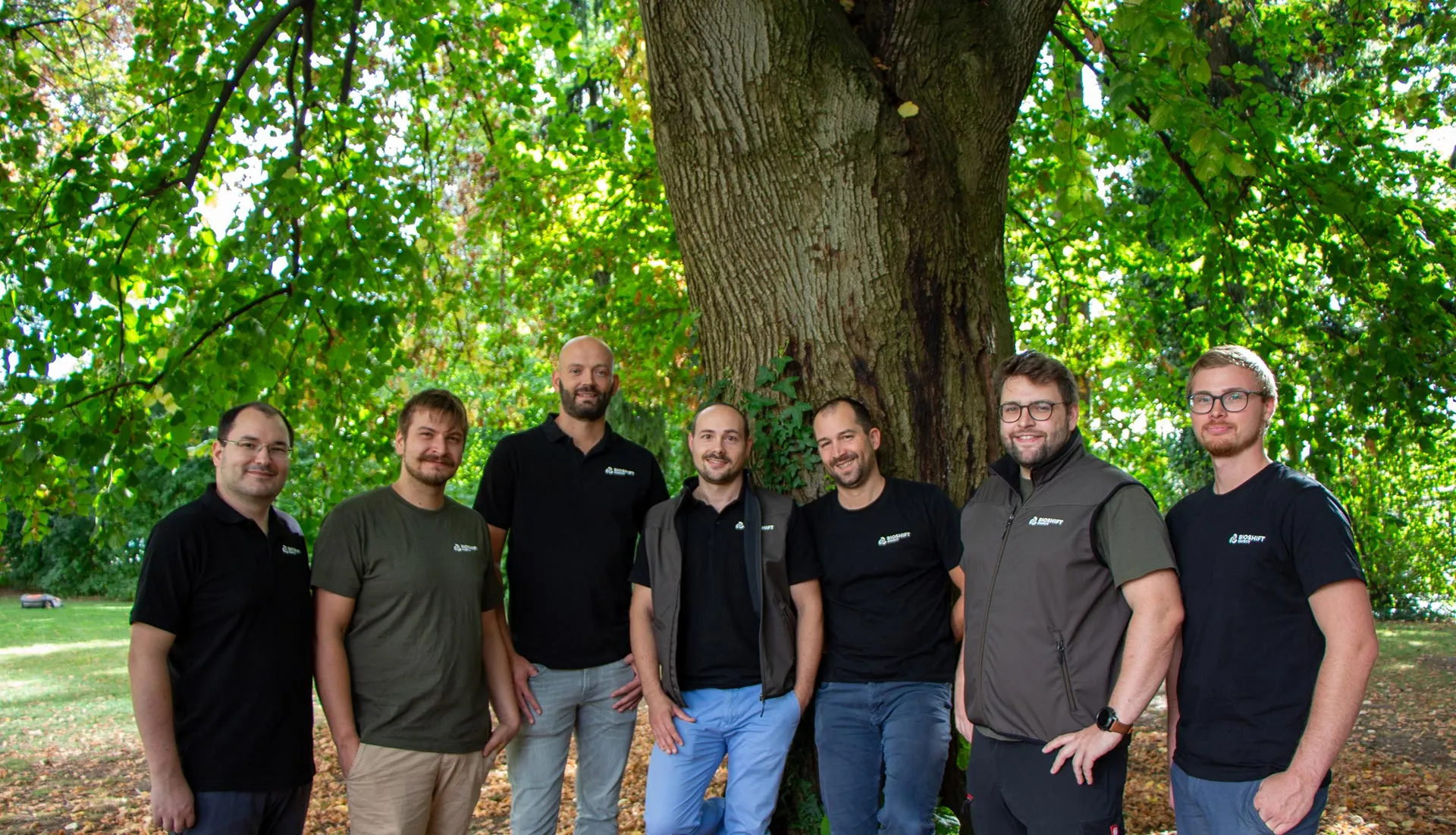 Bioshift team members in front of a tree