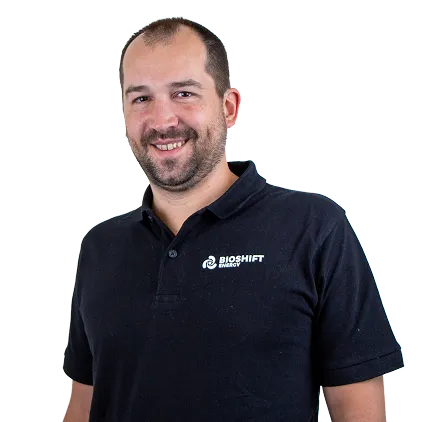 Portrait of a team member of BIOSHIFT in a black polo shirt with their company logo