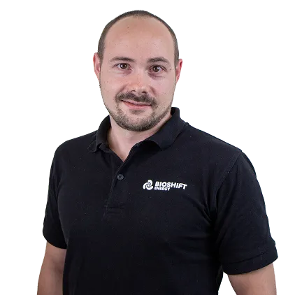 Portrait of a team member of BIOSHIFT in a black polo shirt with their company logo
