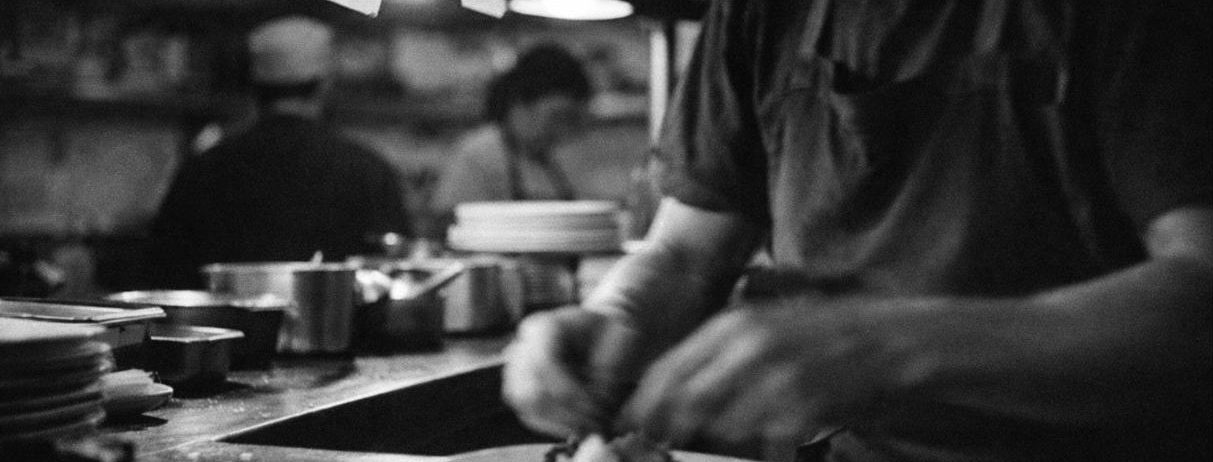A cook plating on a restaurant line during service