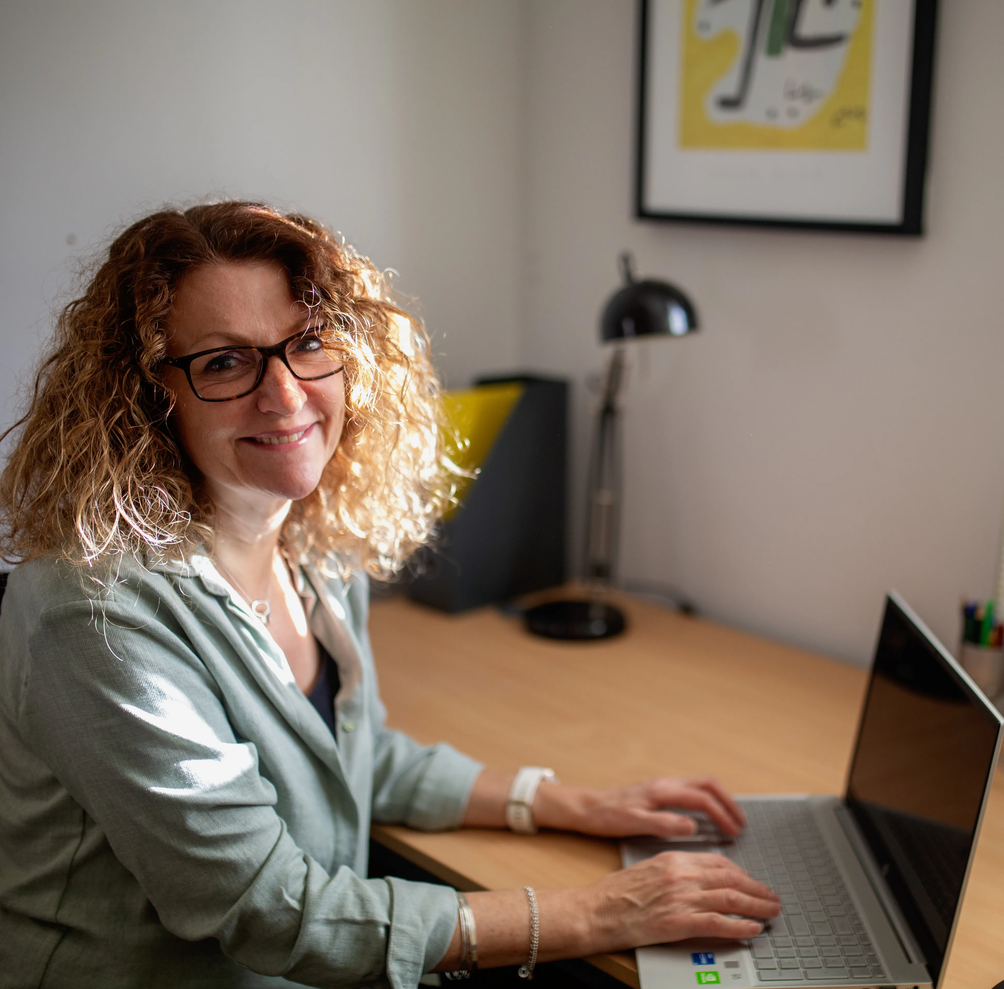 Jeni working at a desk inside the Anchor Counselling office