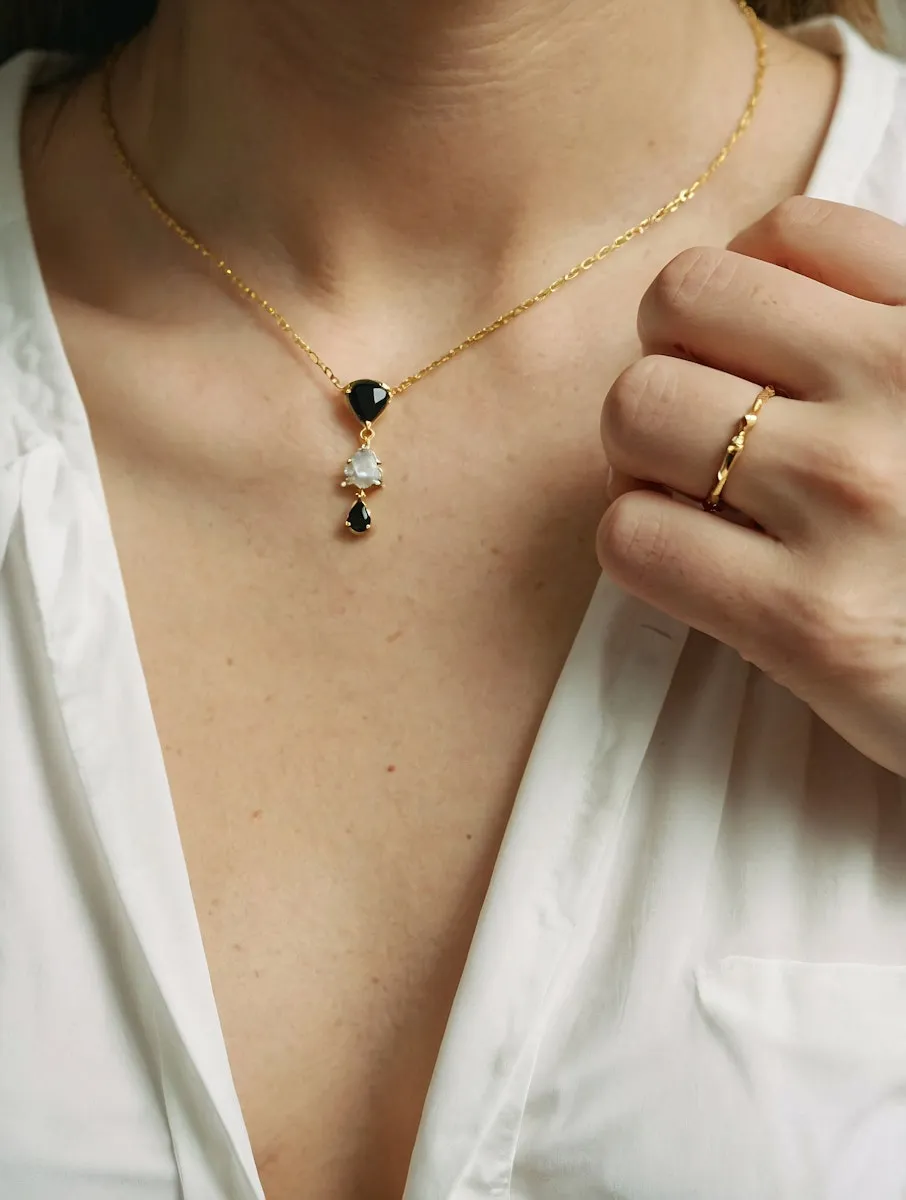 A close up of a person wearing a necklace.