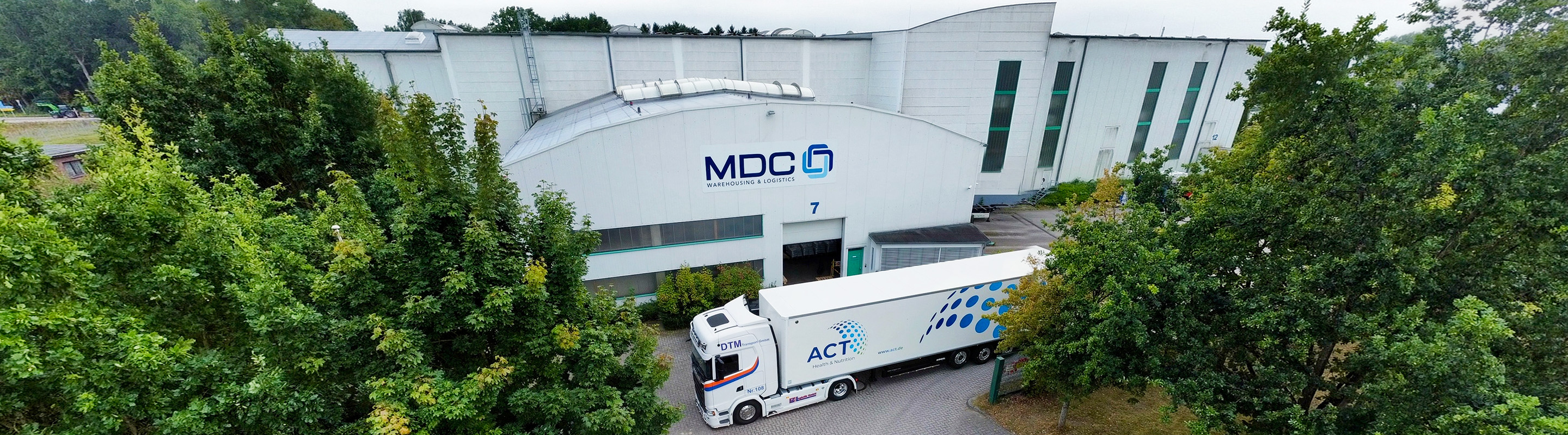 A truck in front of a warehouse