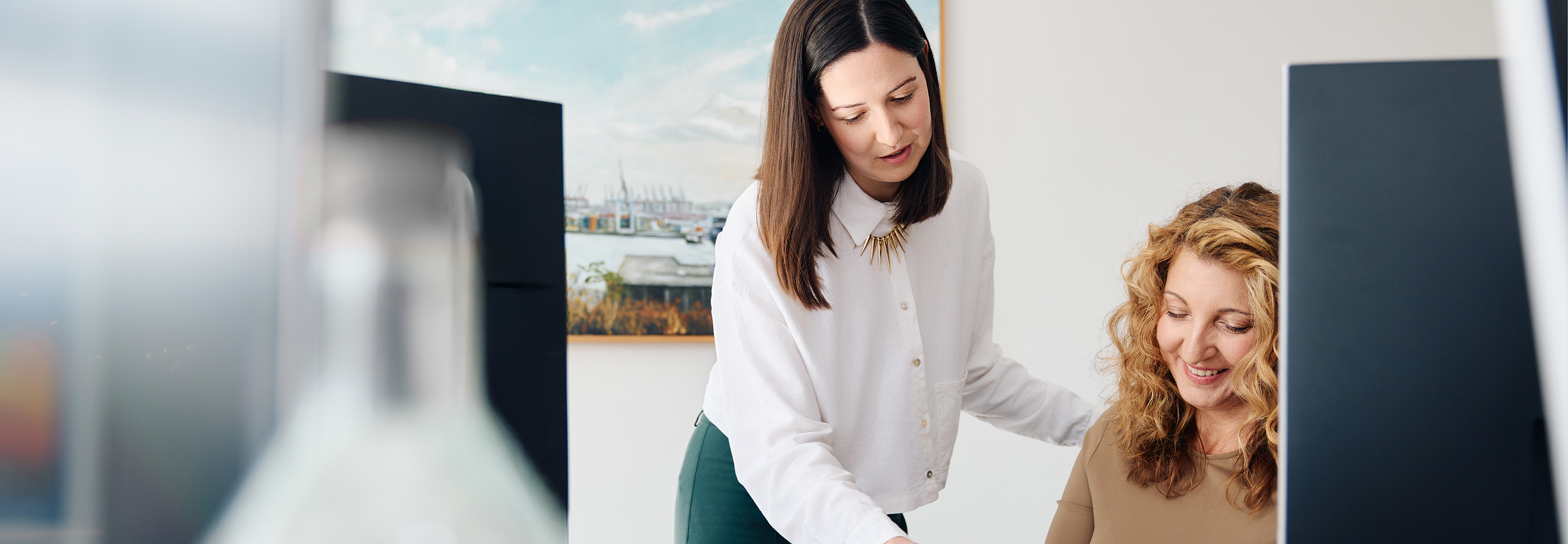 Two women looking at a paper