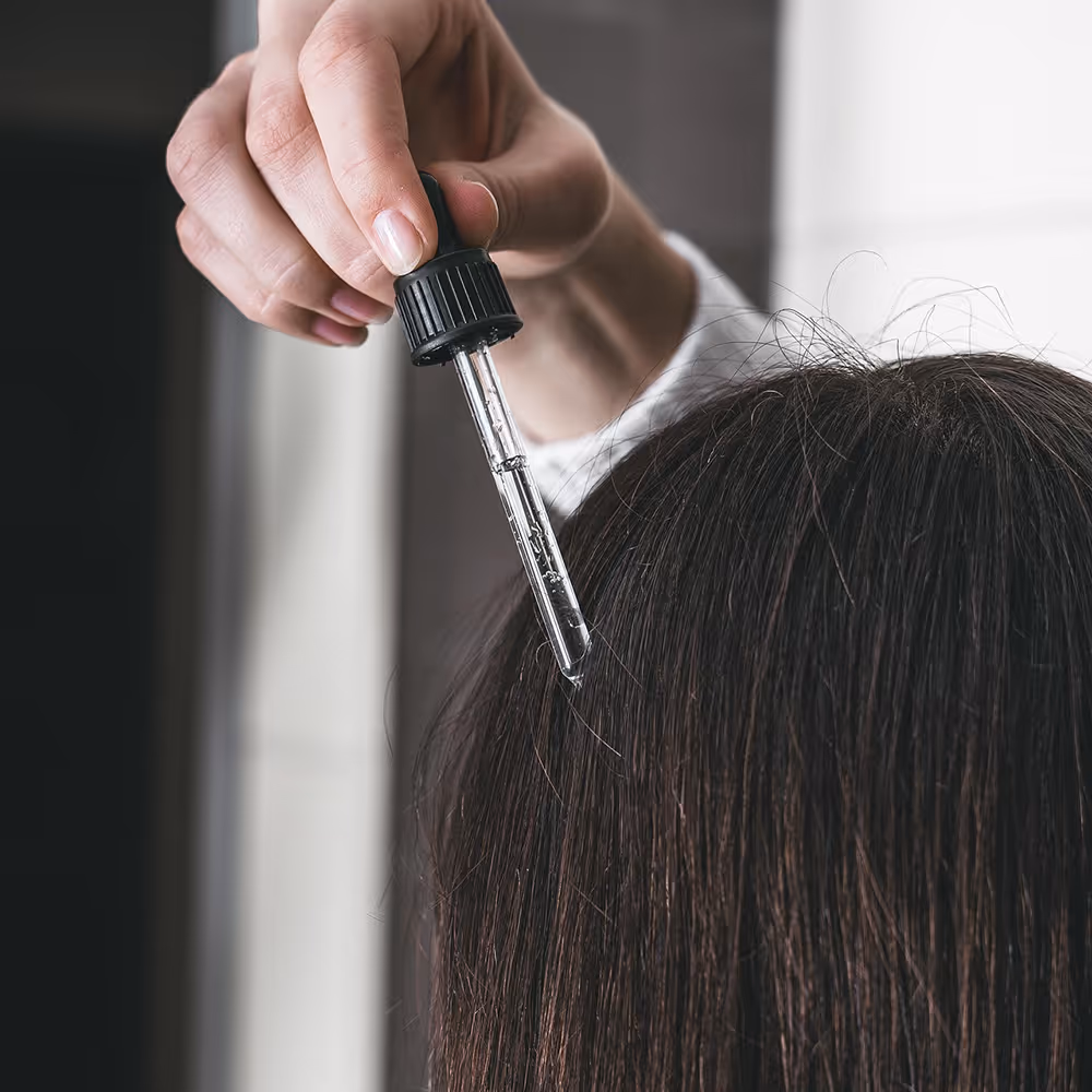 A person using hair oil