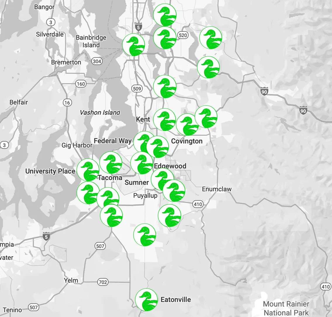 Map highlighting locations with green swan symbols around Tacoma, Washington, for wildlife observation.

