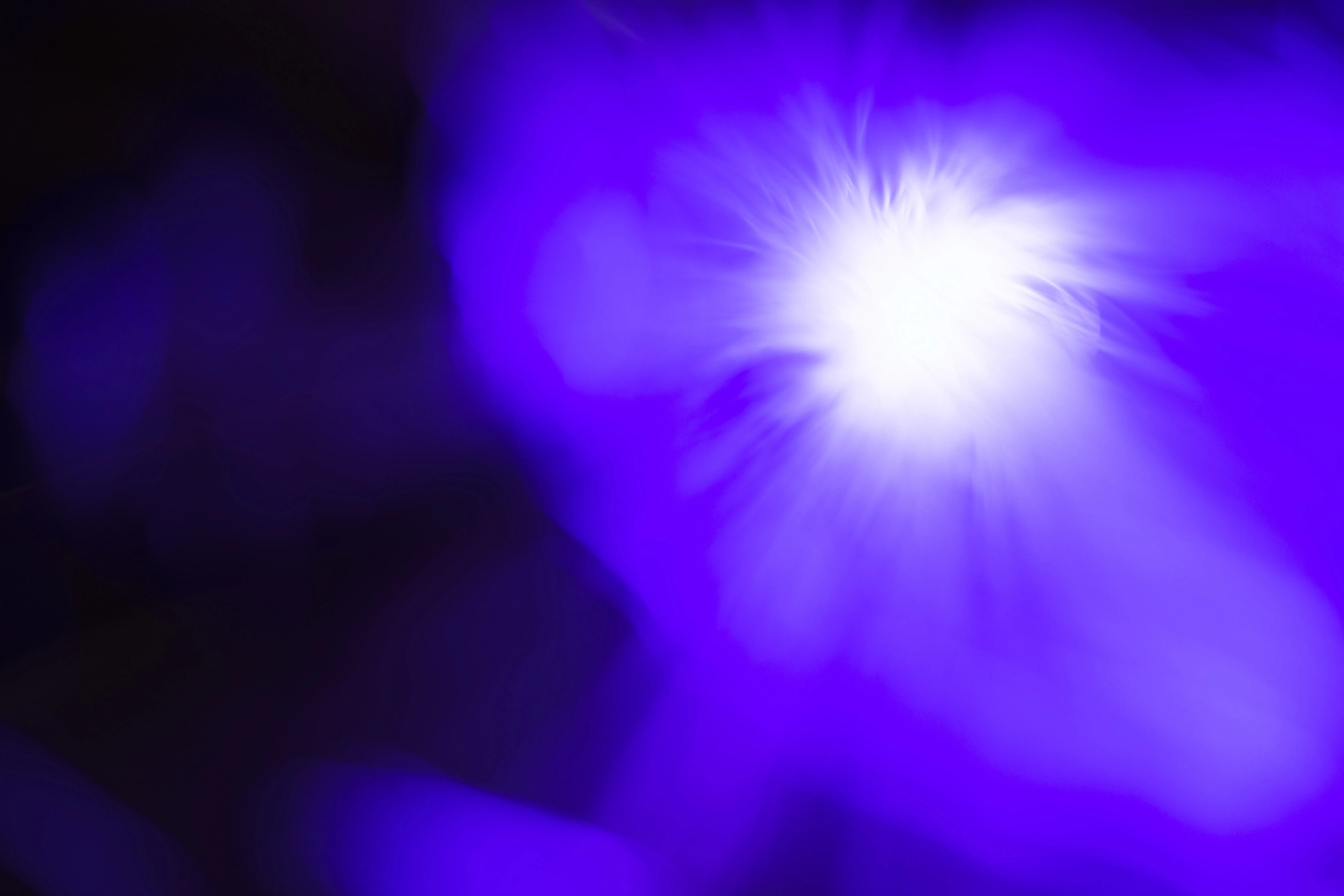 A vibrant abstract blue and white light burst, creating a mystical atmosphere suitable for digital backgrounds.
