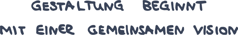 Handwritten German text saying 'Gestaltung beginnt mit einer gemeinsamen Vision' in blue ink on black.