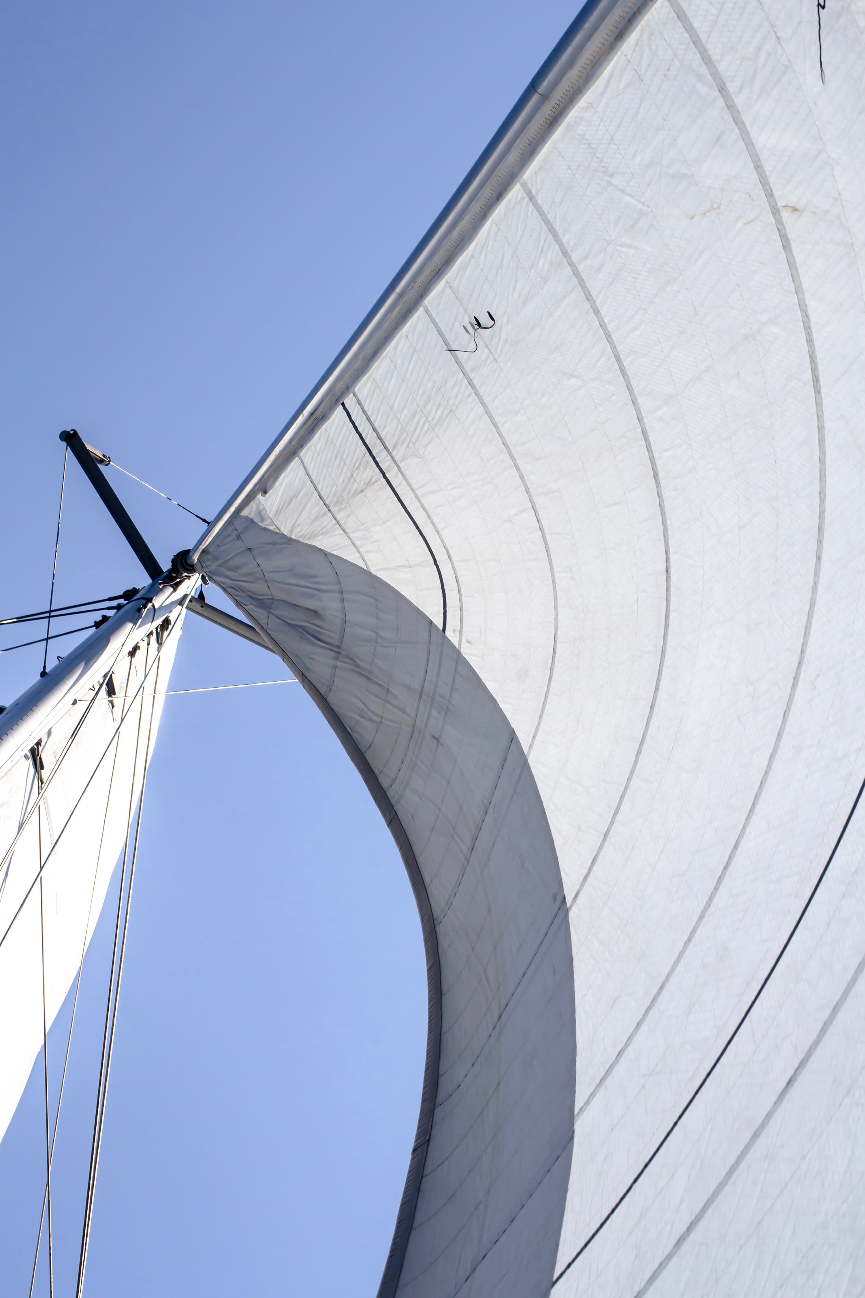 Minimal composition of sails and sky — fine art sailing photography by Maison TALI.
