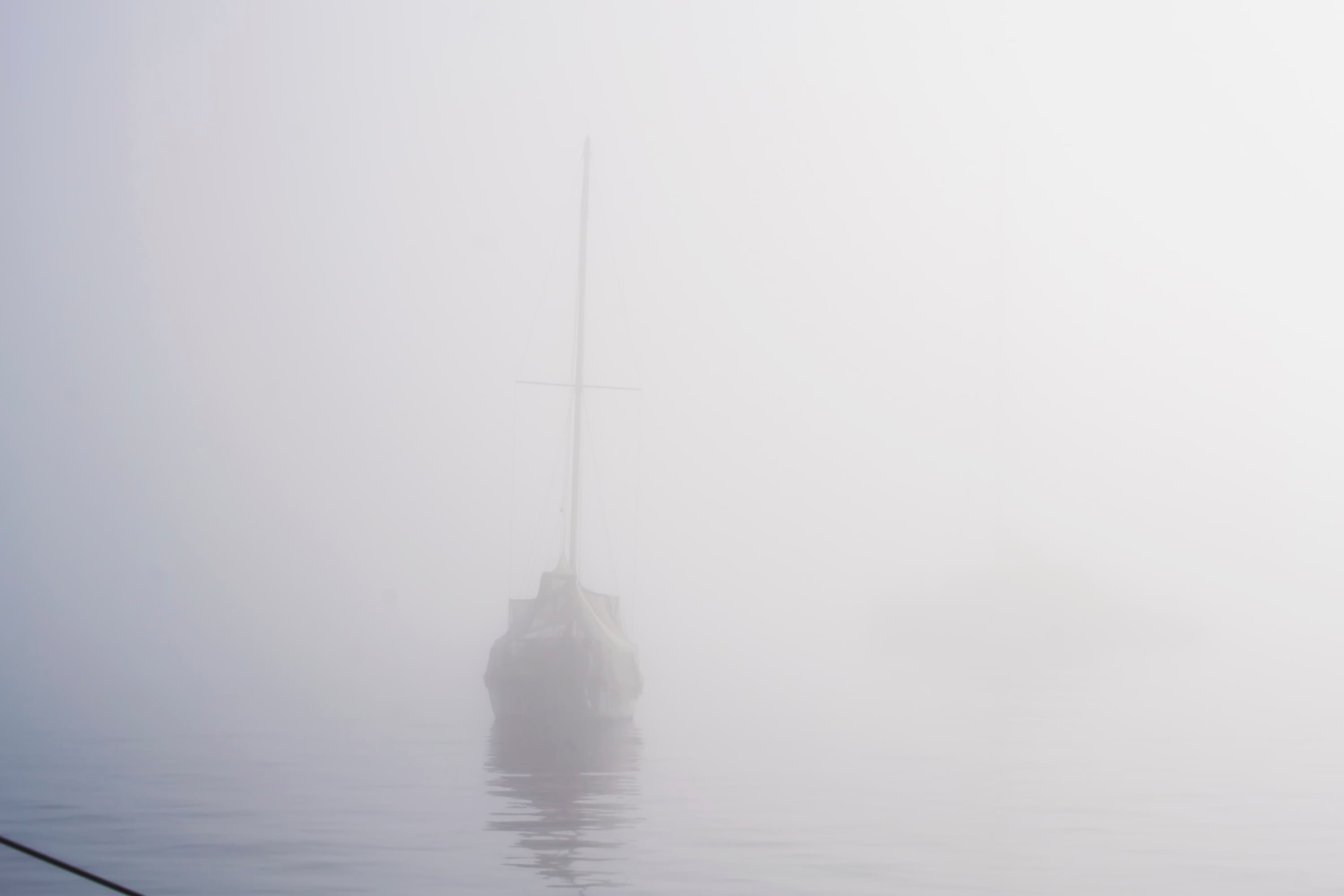 Sailing vessel surrounded by fog — poetic black and white ocean image by Maison TALI.