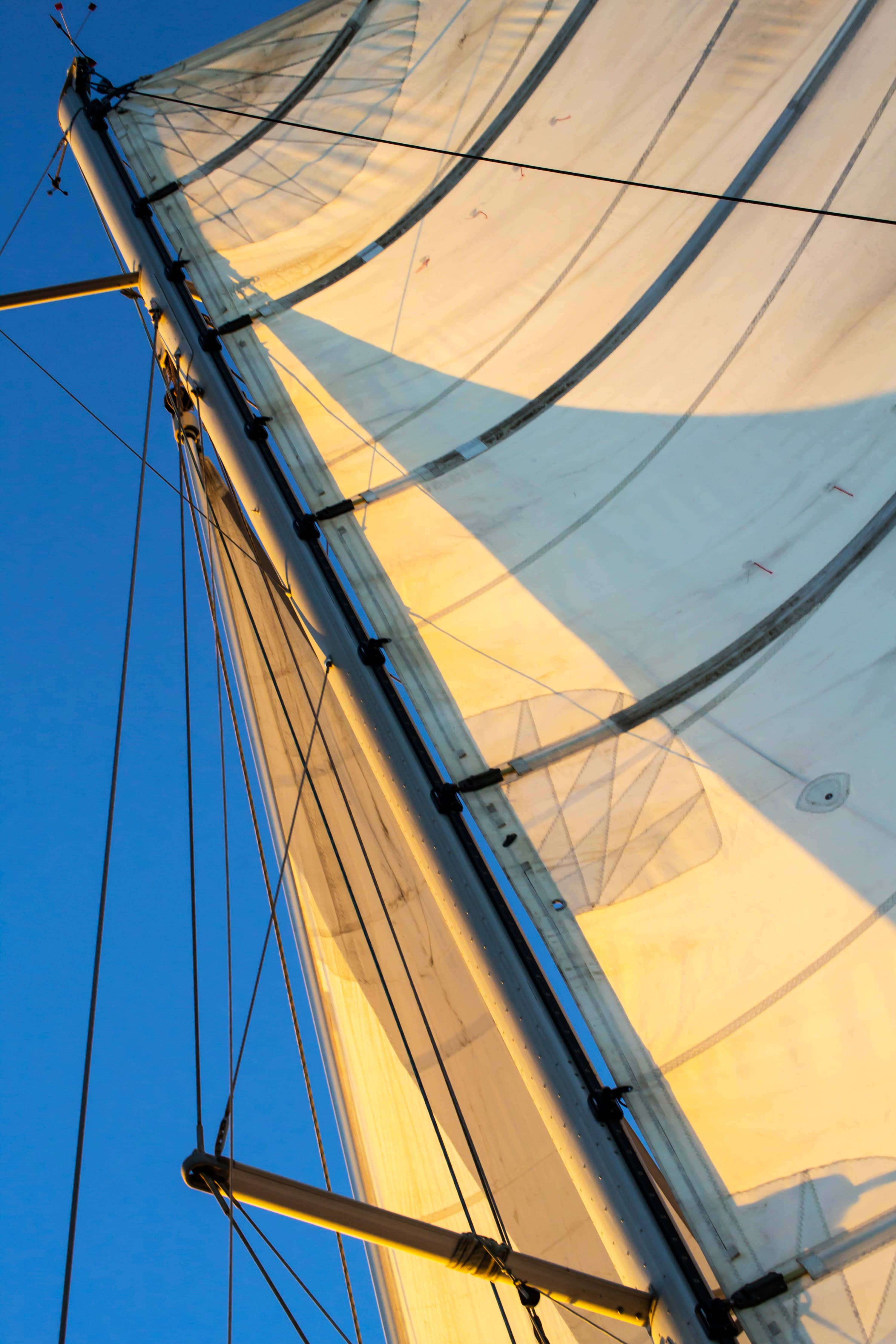 Geometry of white sails and sky — abstract sailing image by Maison TALI.