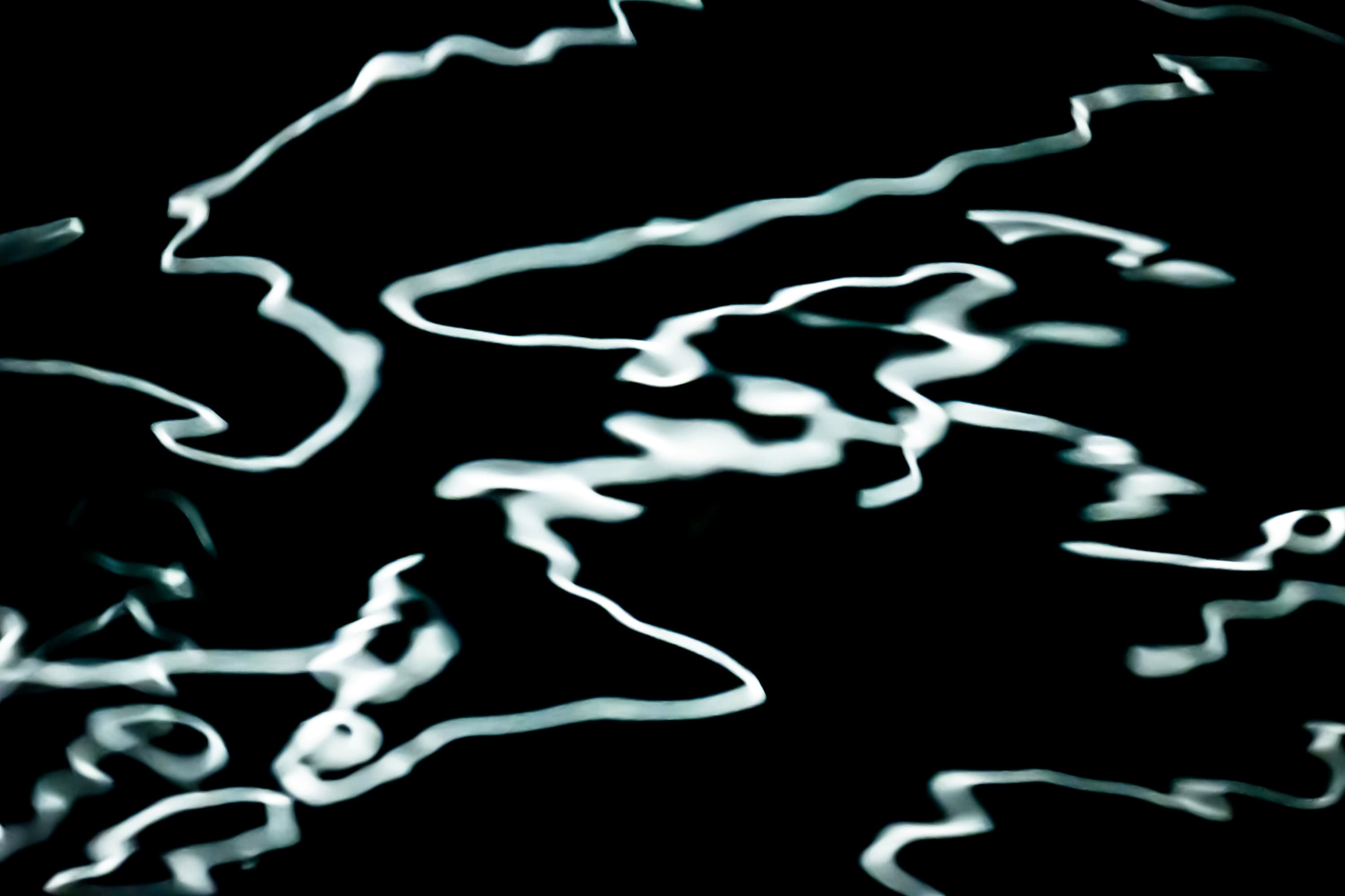 Abstract fine art ocean photography — black water and lunar reflections forming a silent dance of light by Maison TALI.