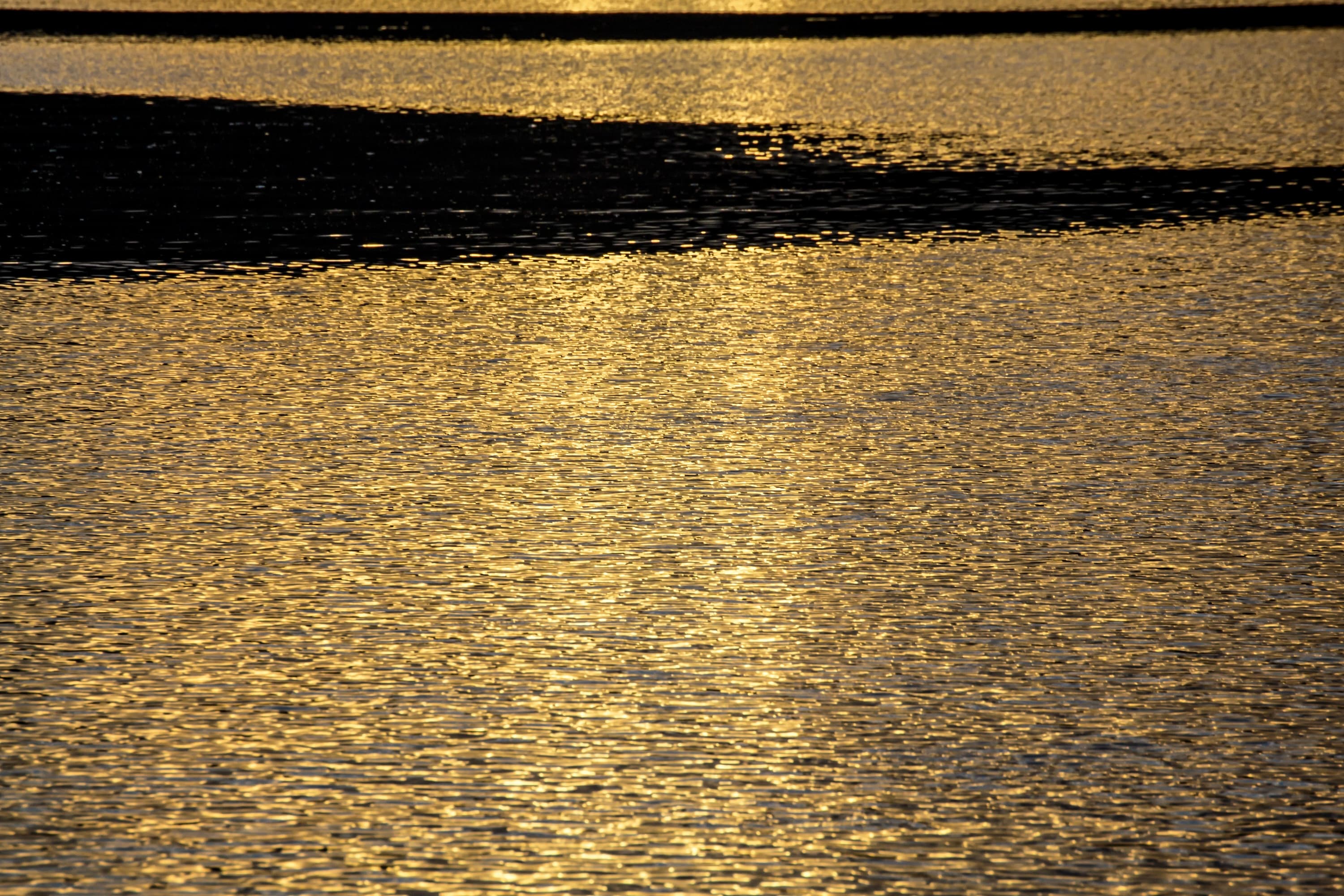 Reflections and light patterns on calm water — fine art ocean photography by Maison TALI.