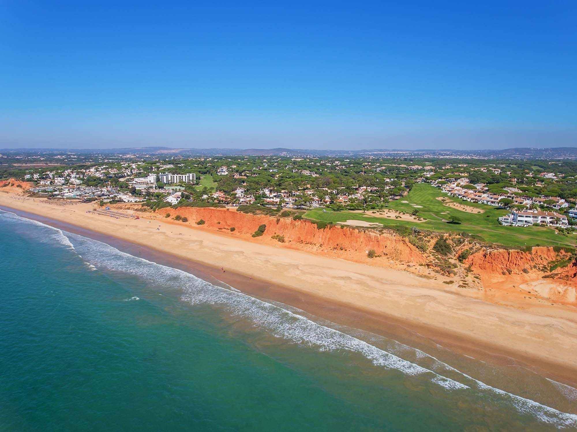 Aerial view of the golden beach and pristine golf course at Vale de Lobo in Portugal's Golden Triangle