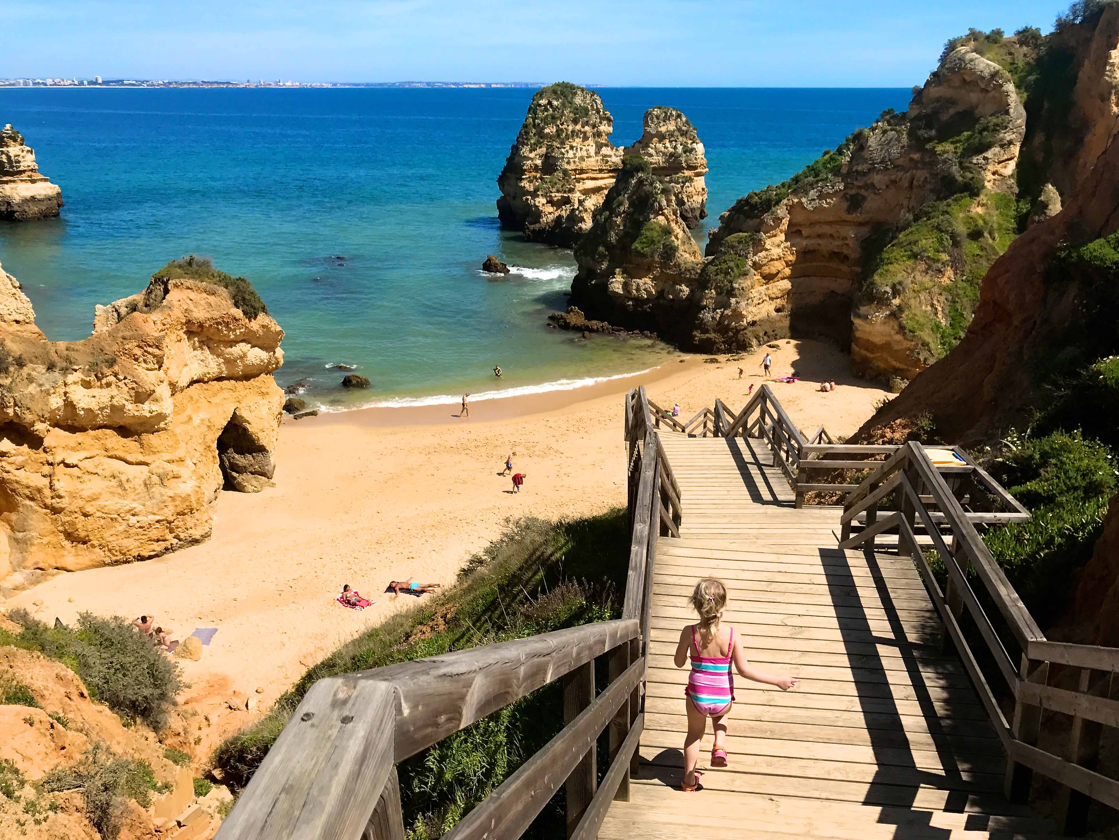 Family playing on secluded beach in the Algarve, Portugal