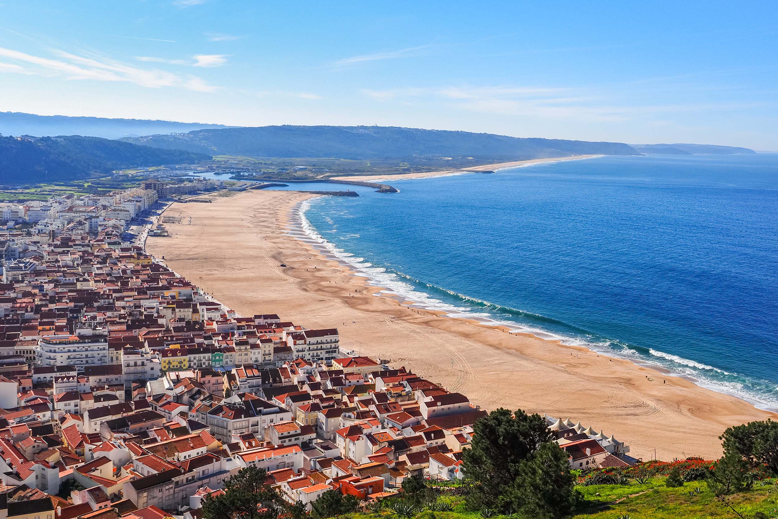 Stunning panoramic view from the hill to the sandy beach of Praia da Nazaré and Nazaré town