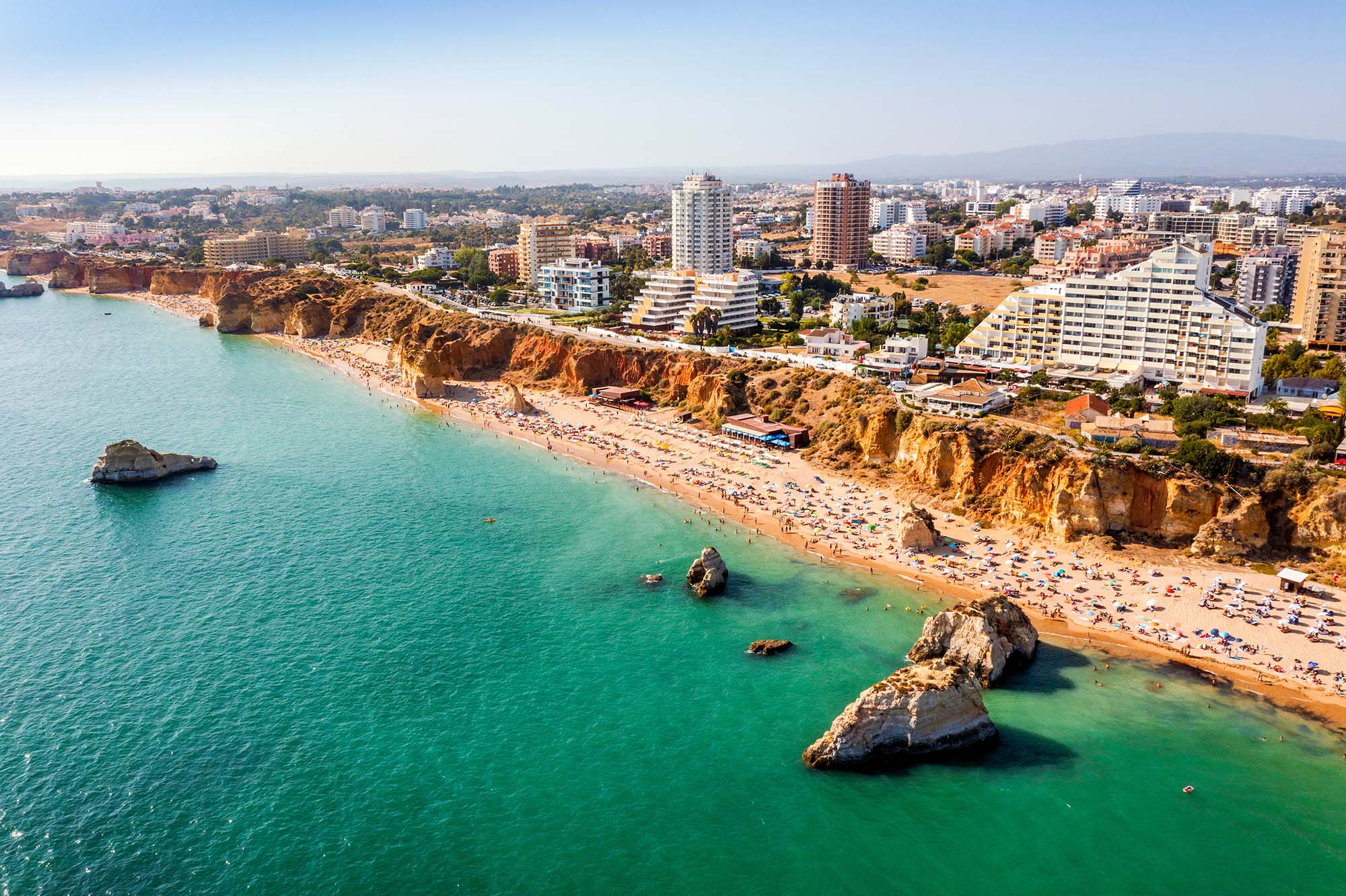 Aerial view of the popular tourist town of Portimao with wide sandy Rocha beach, in the Algarve