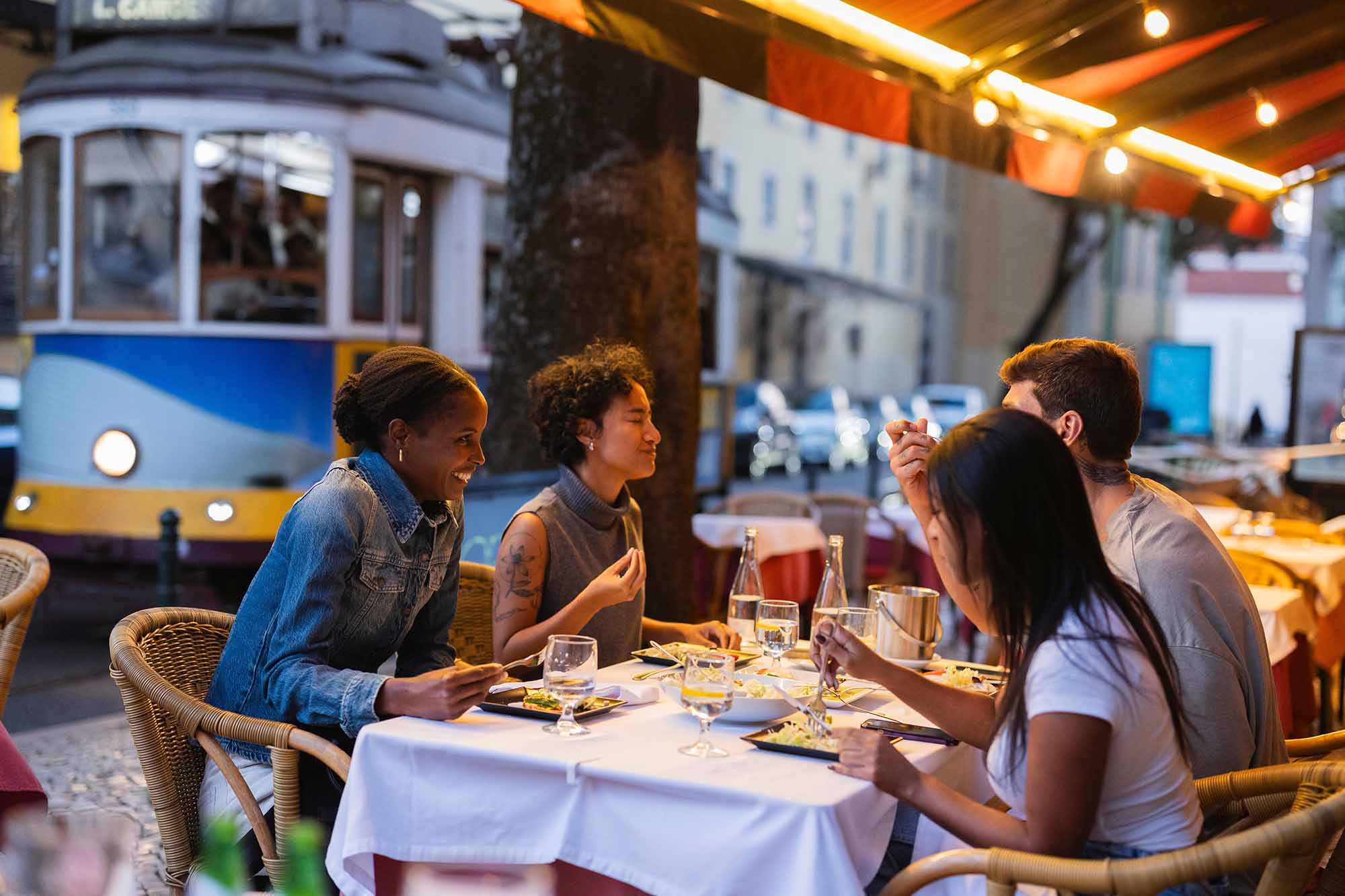 Friends enjoying a meal at a restaurant in Portugal