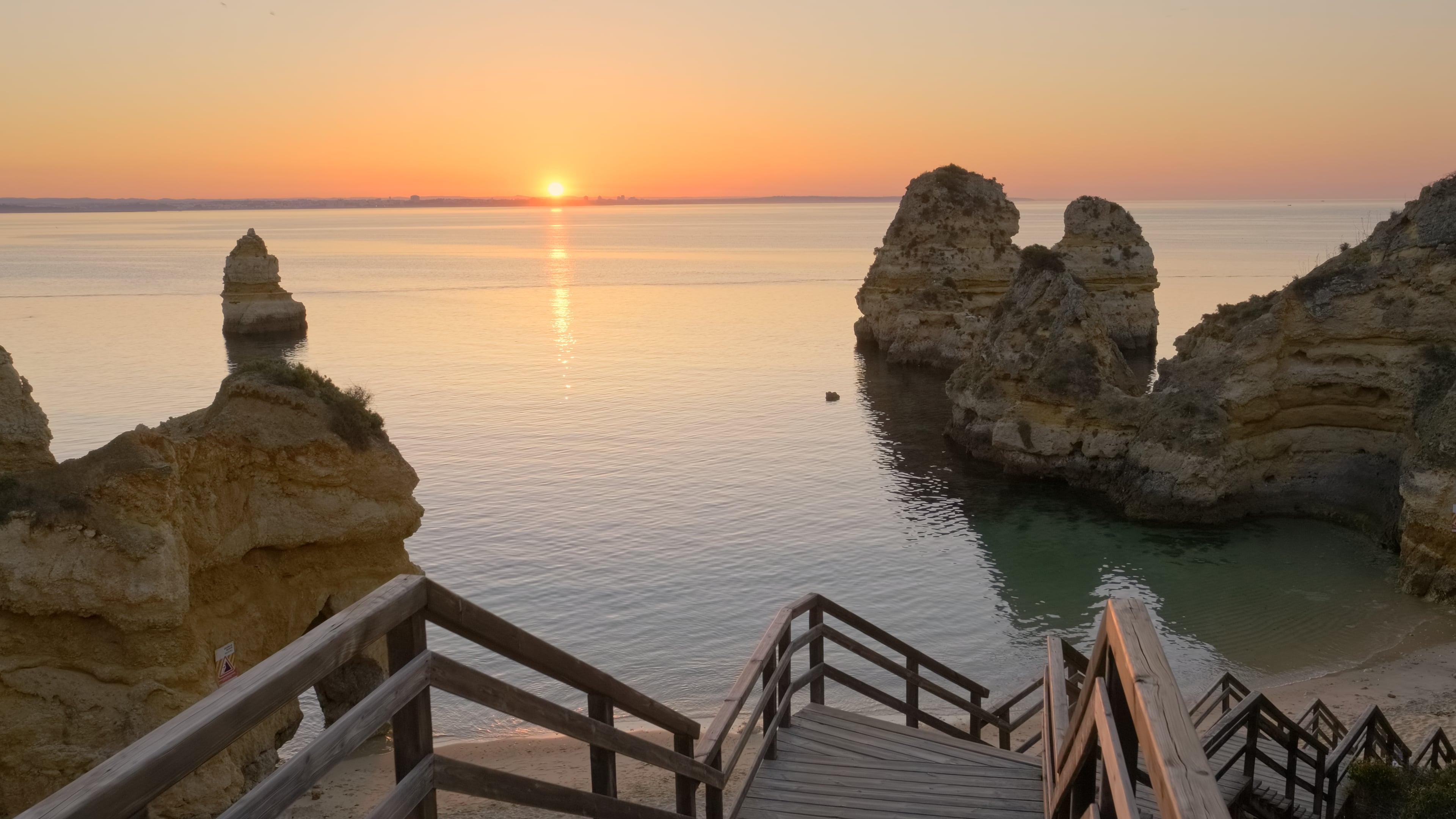 View over the ocean at sunset from a secluded beach in the Algarve, Portugal